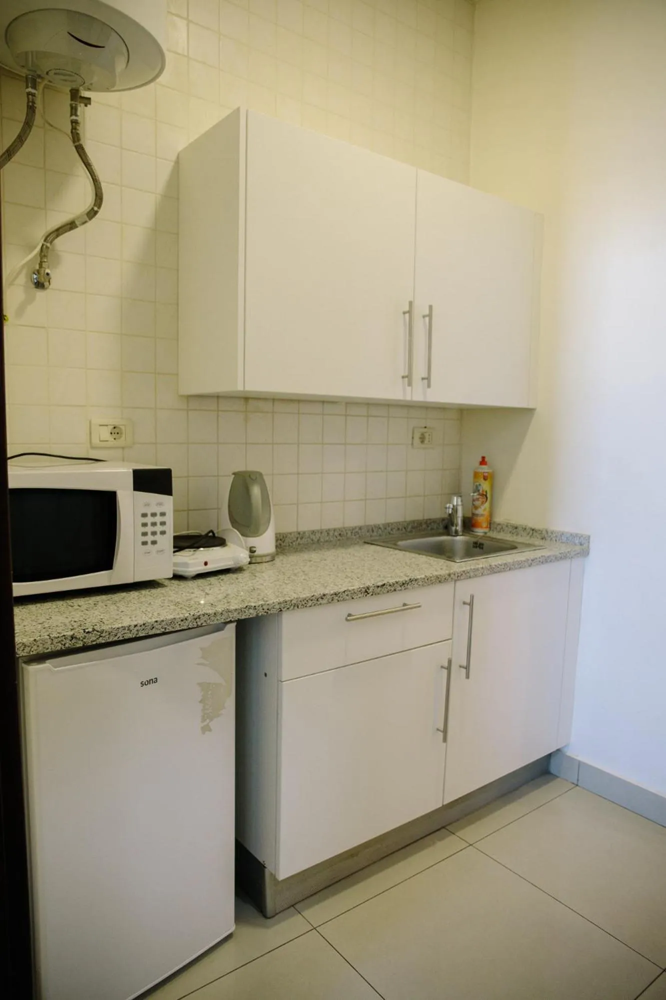 Kitchen or kitchenette in Madina Suites