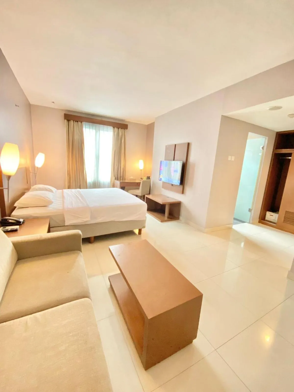 Seating area, Bed in Triniti Hotel Gajah Mada