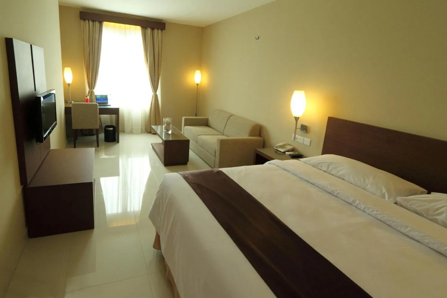 Living room, Bed in Triniti Hotel Gajah Mada
