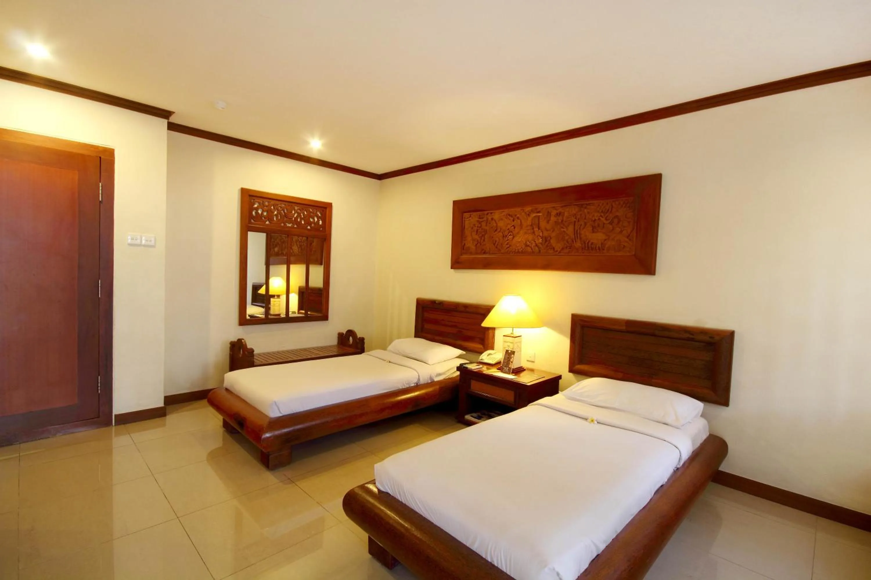 Bed in Grand Balisani Suites Hotel