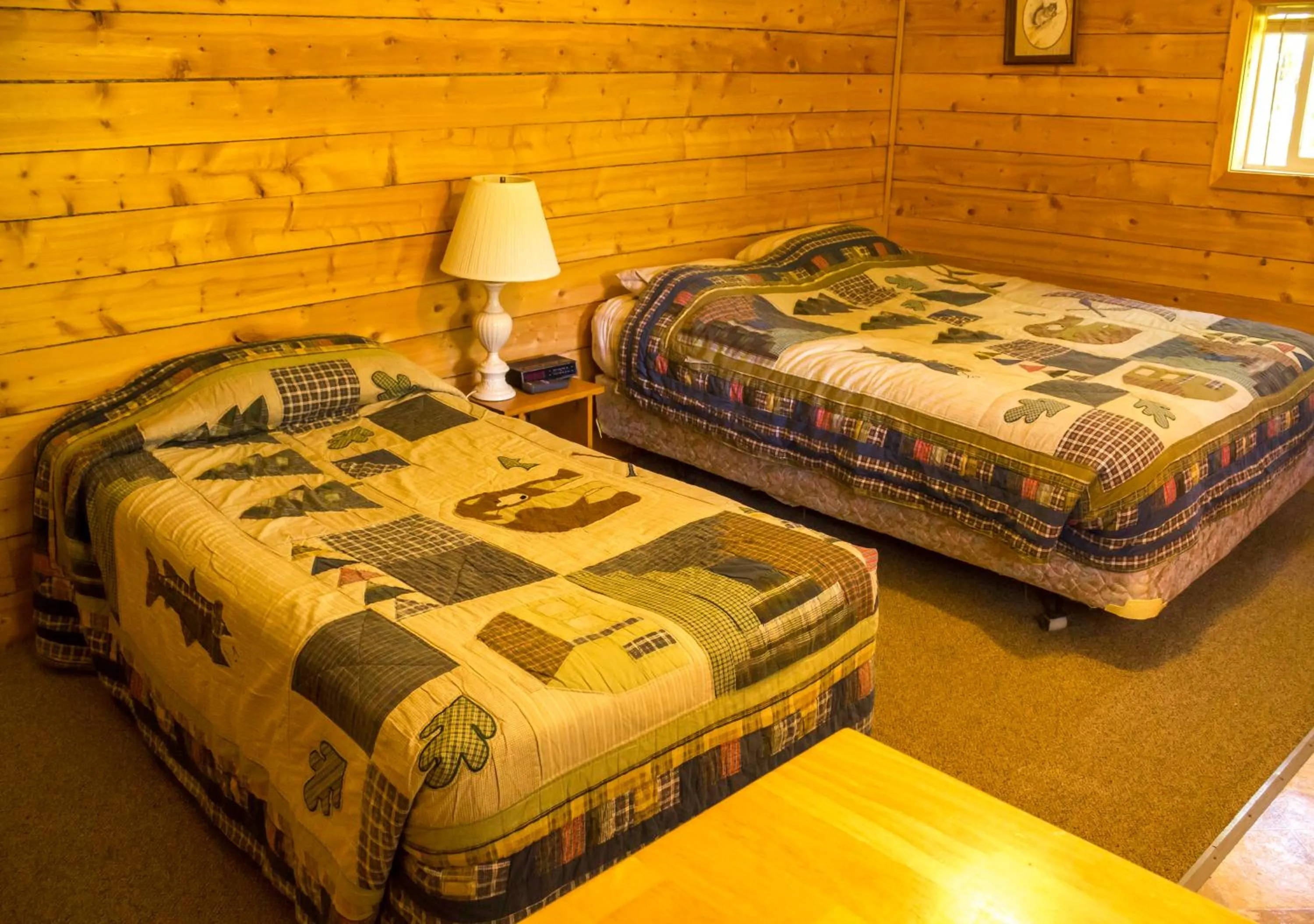 Bed in Midnight Sun Log Cabins