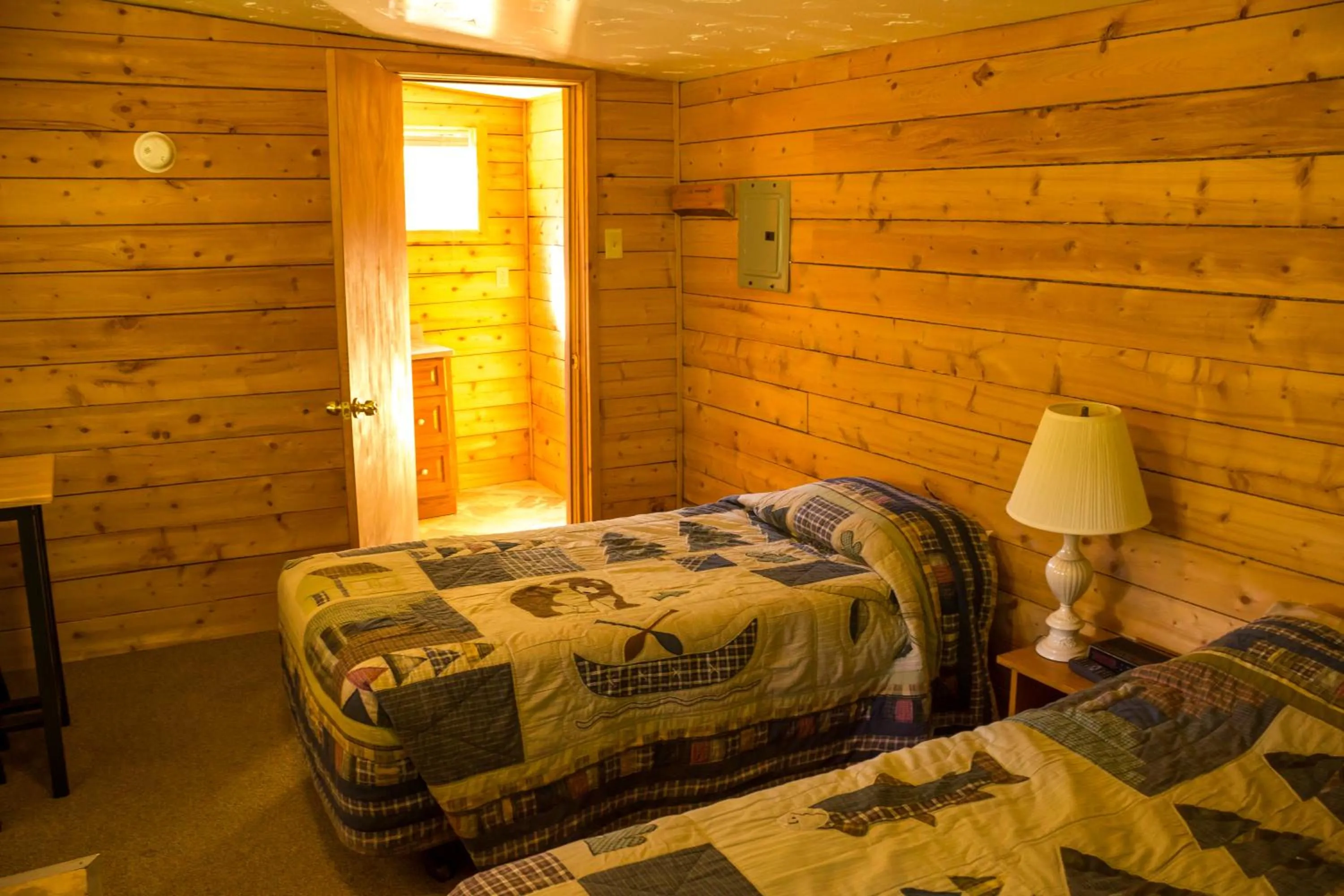 Bed in Midnight Sun Log Cabins