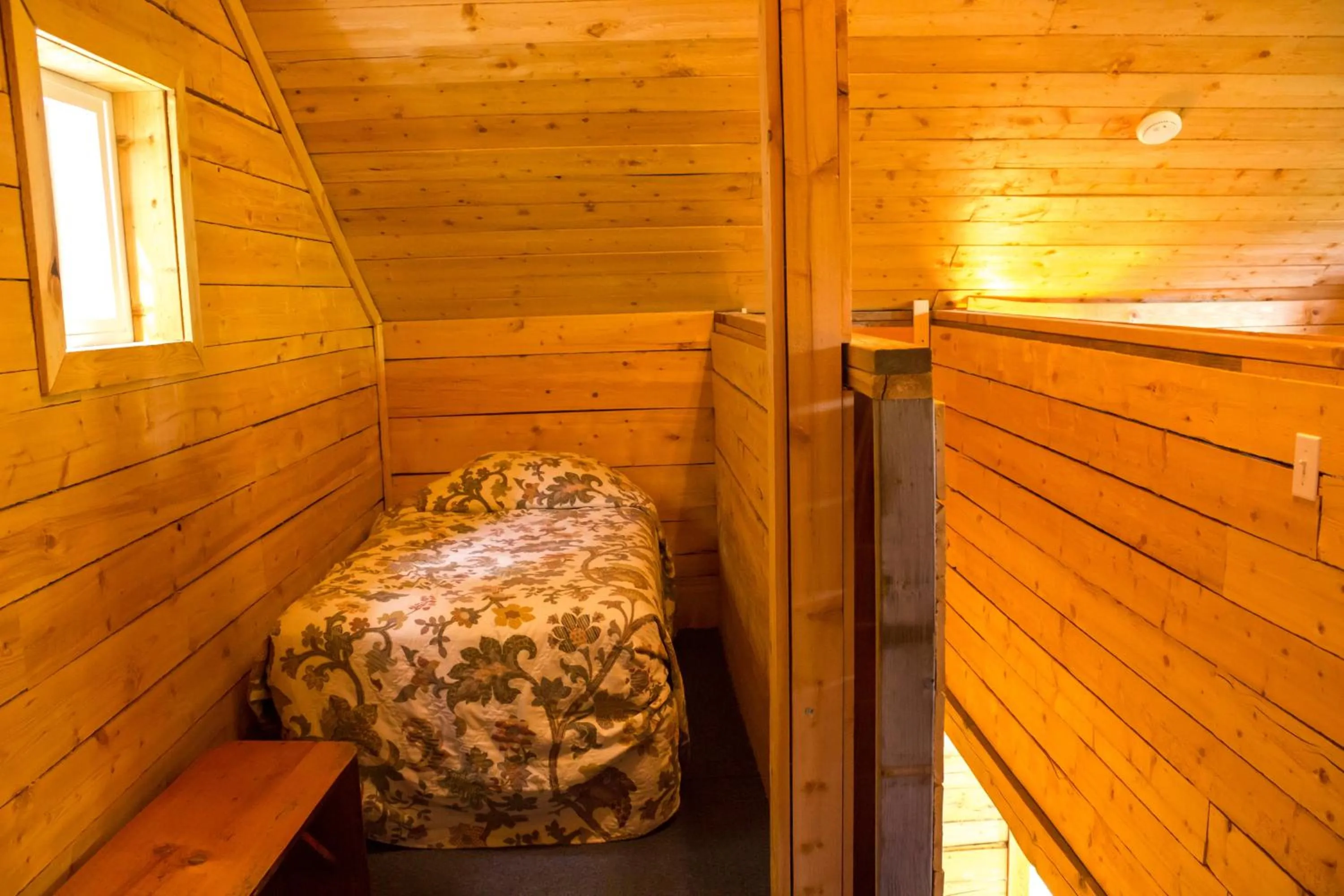 Bed in Midnight Sun Log Cabins