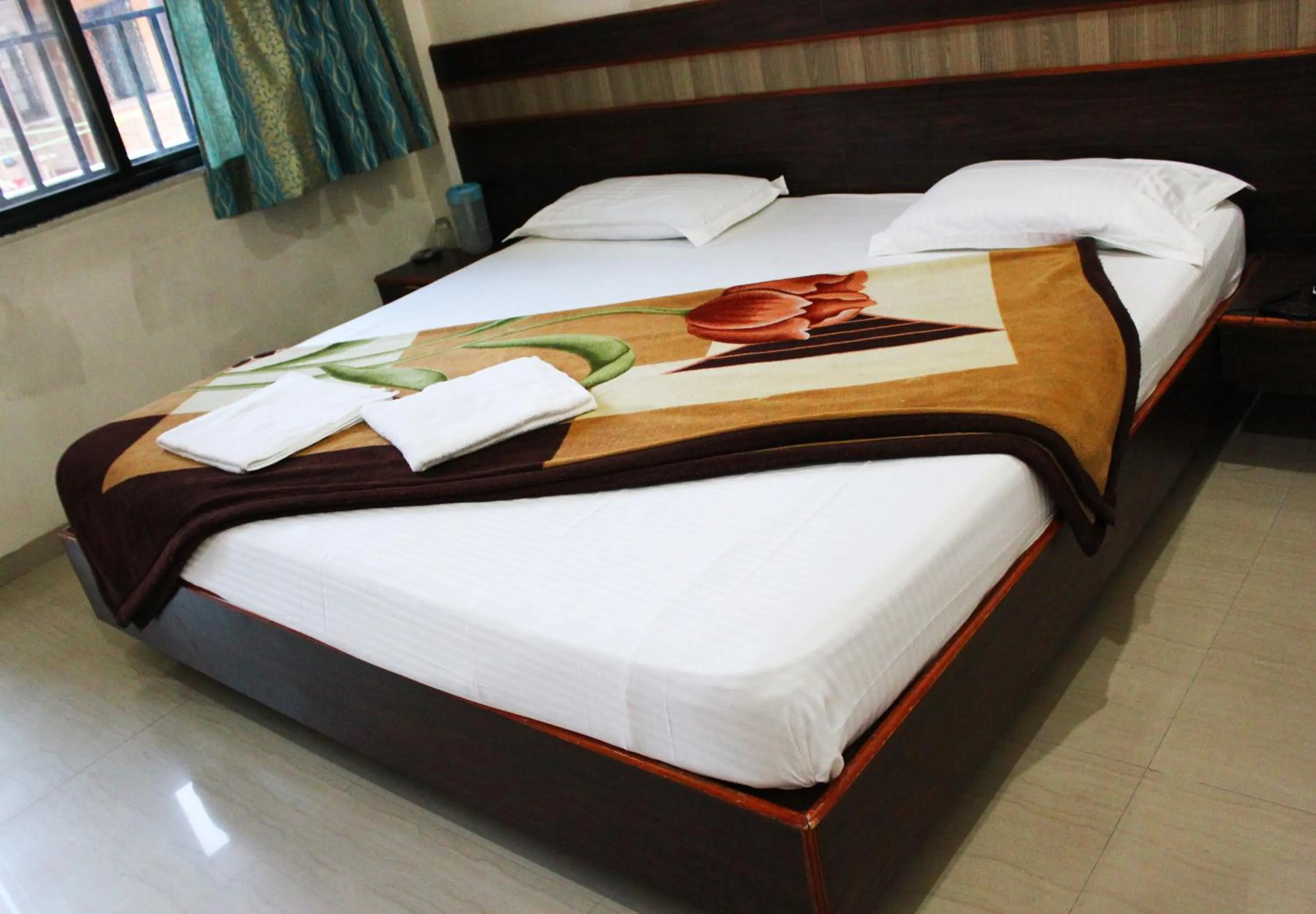 Bed in Sai Atithi Resort