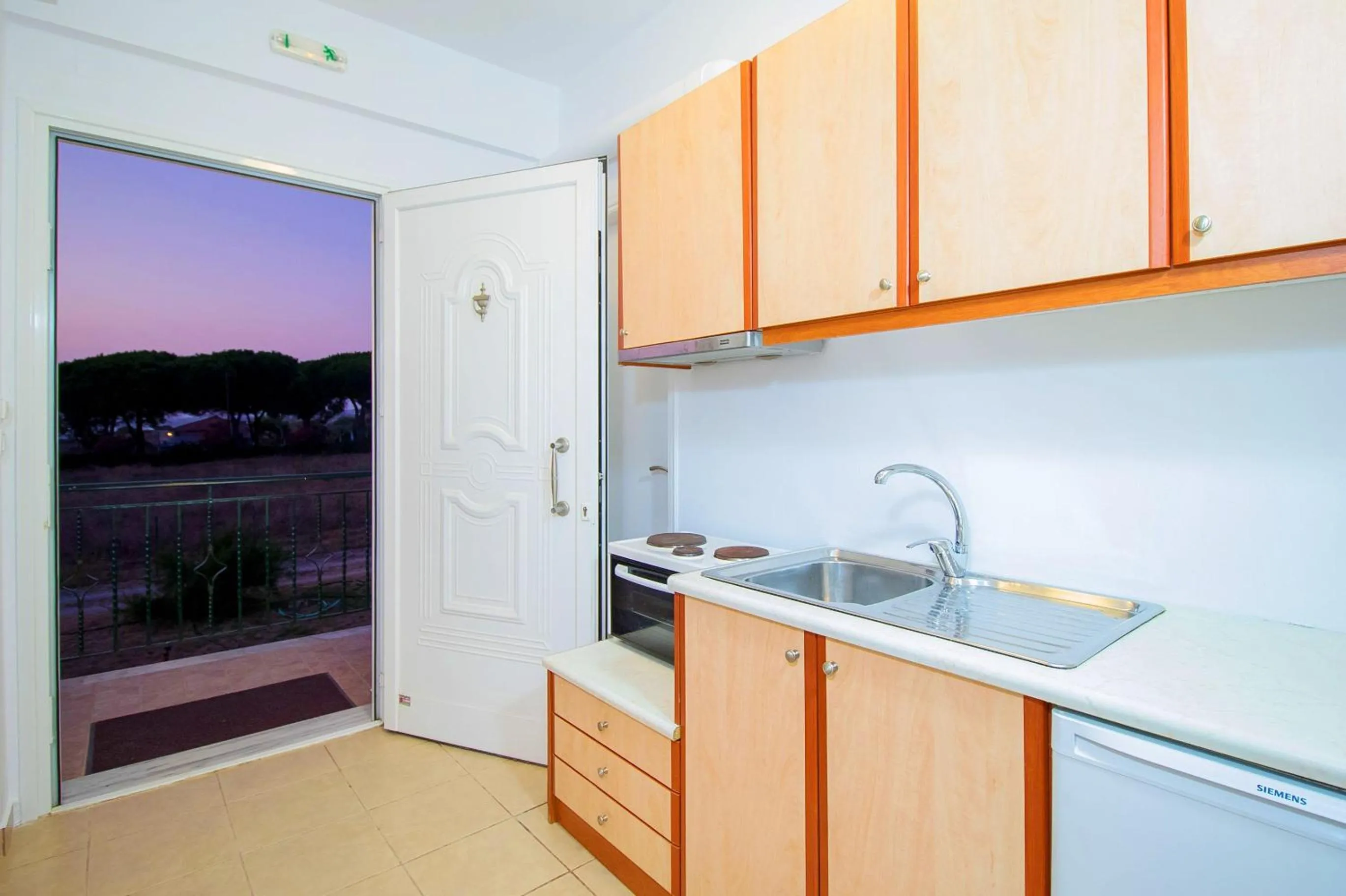 Kitchen or kitchenette in Romanos Beach Villas