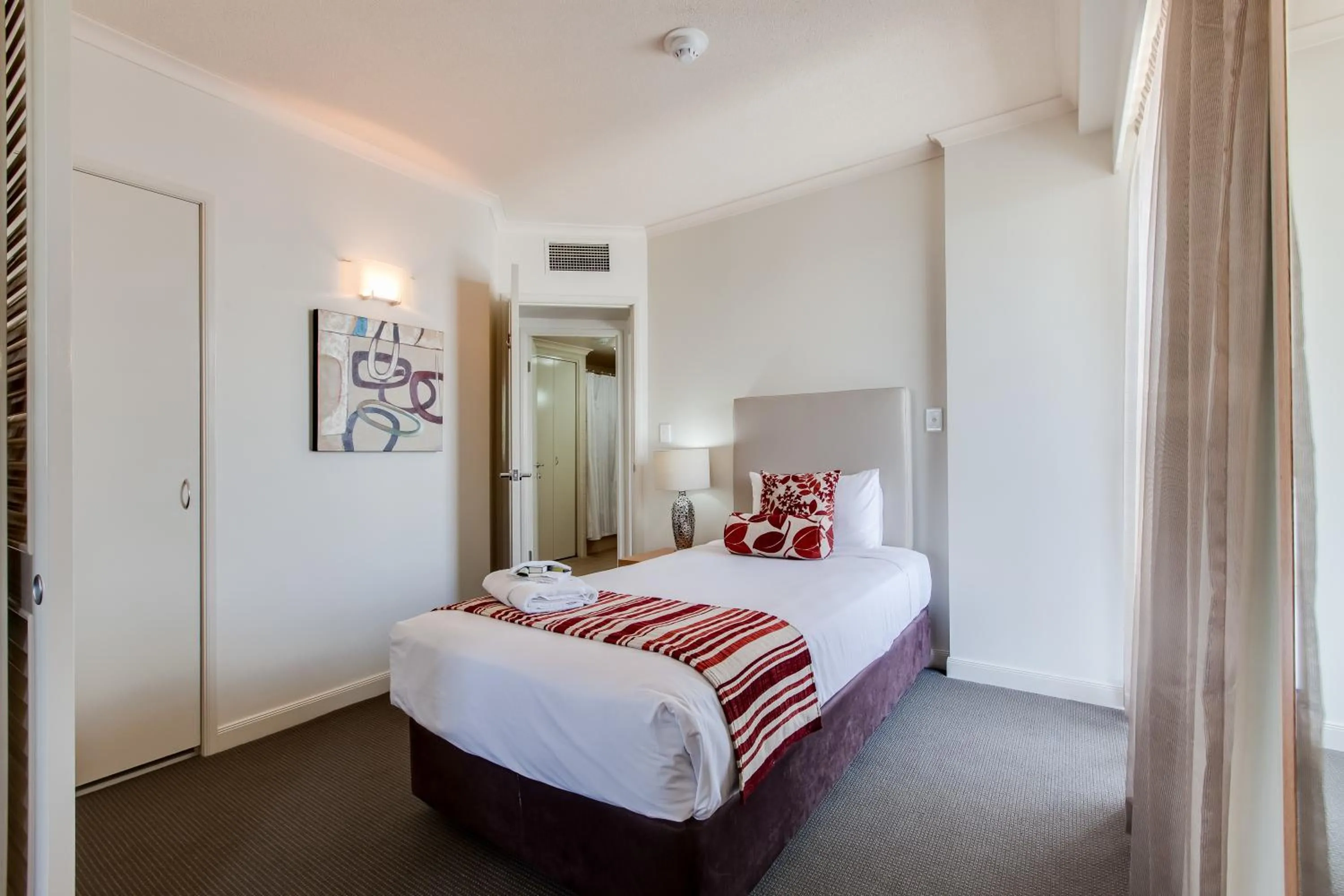 Bed in Cosmo Apartment Hotel