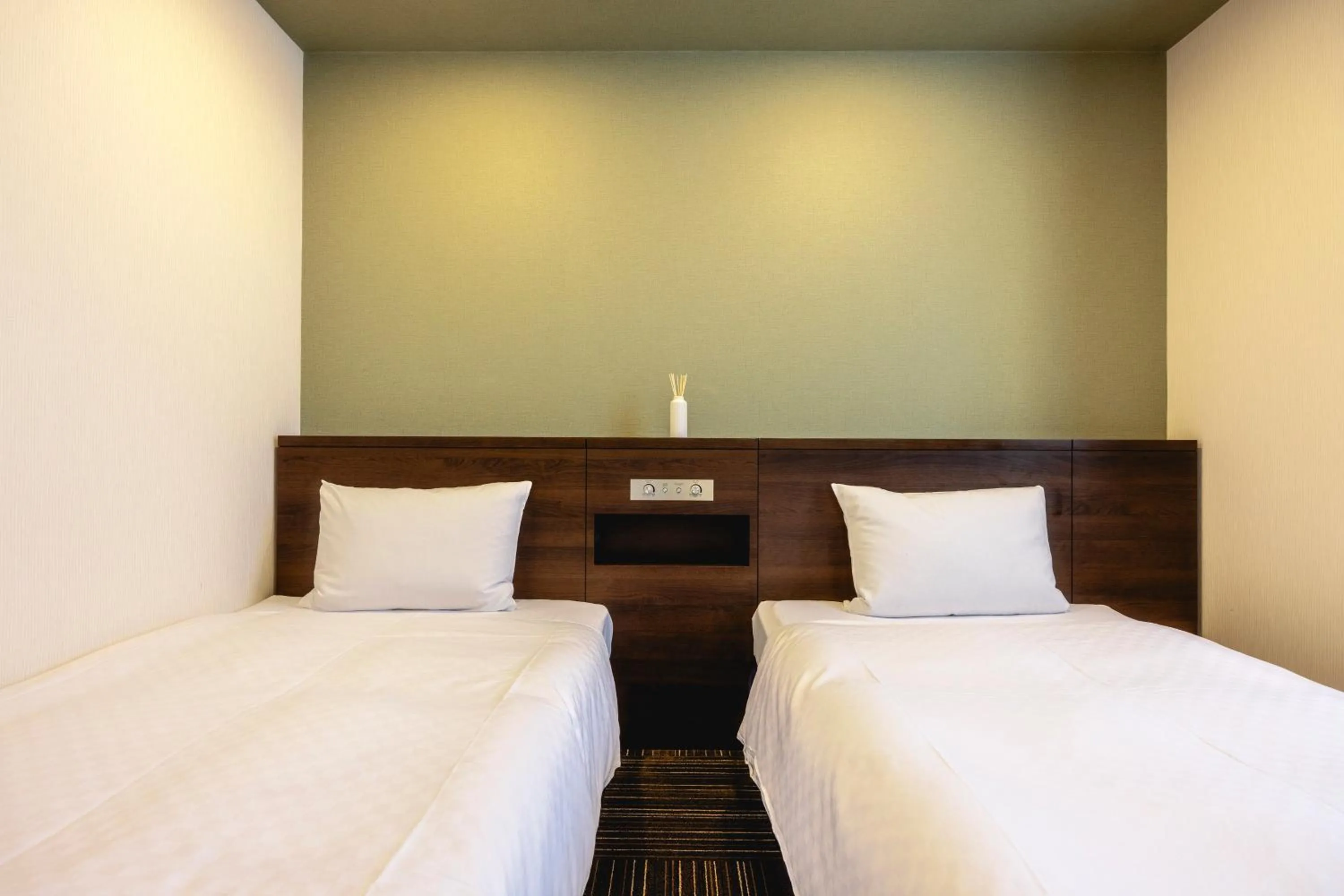 Bed in Kanku Izumiotsu Washington Hotel