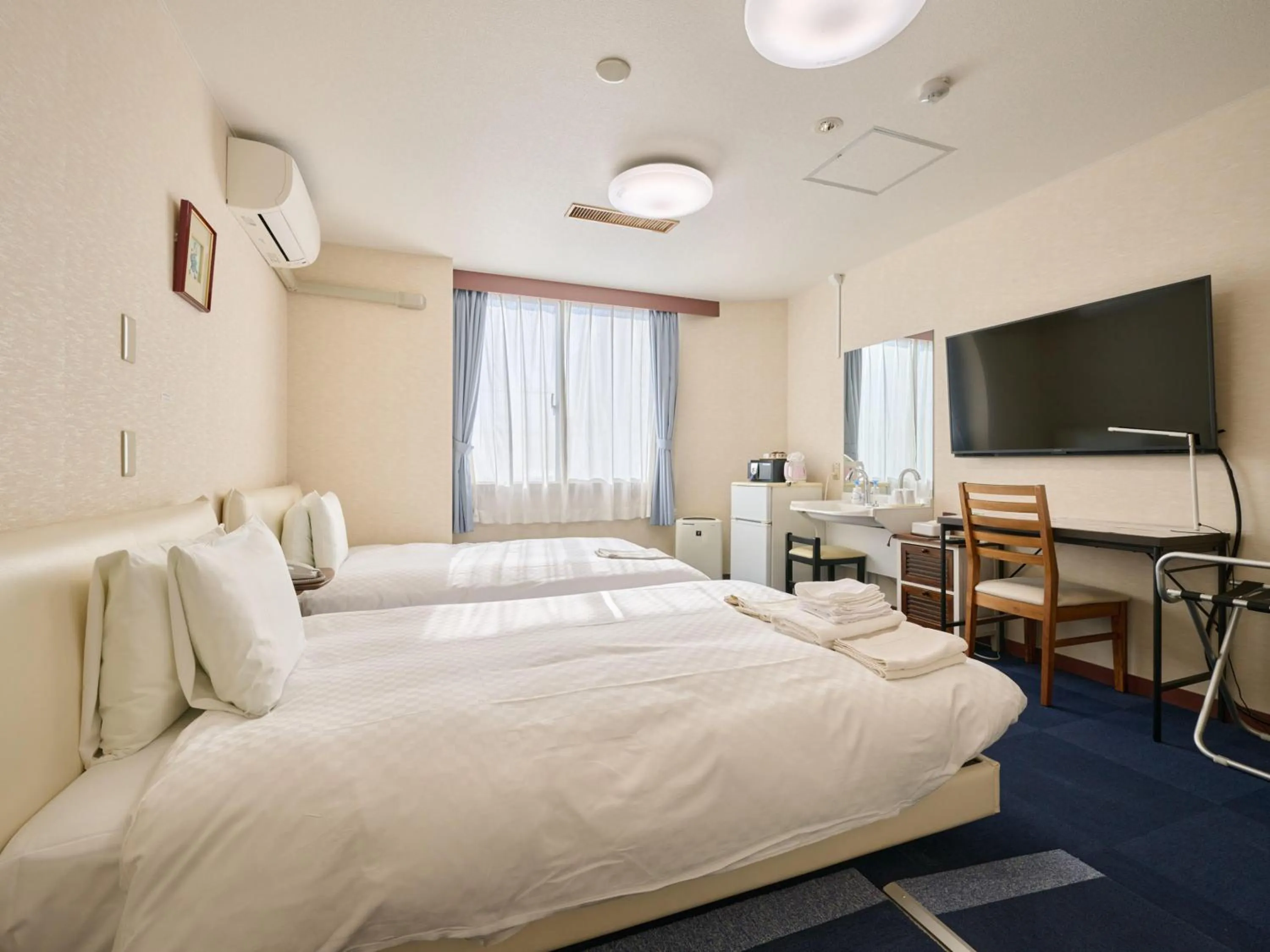 Photo of the whole room, Bed in Okasan Hotel