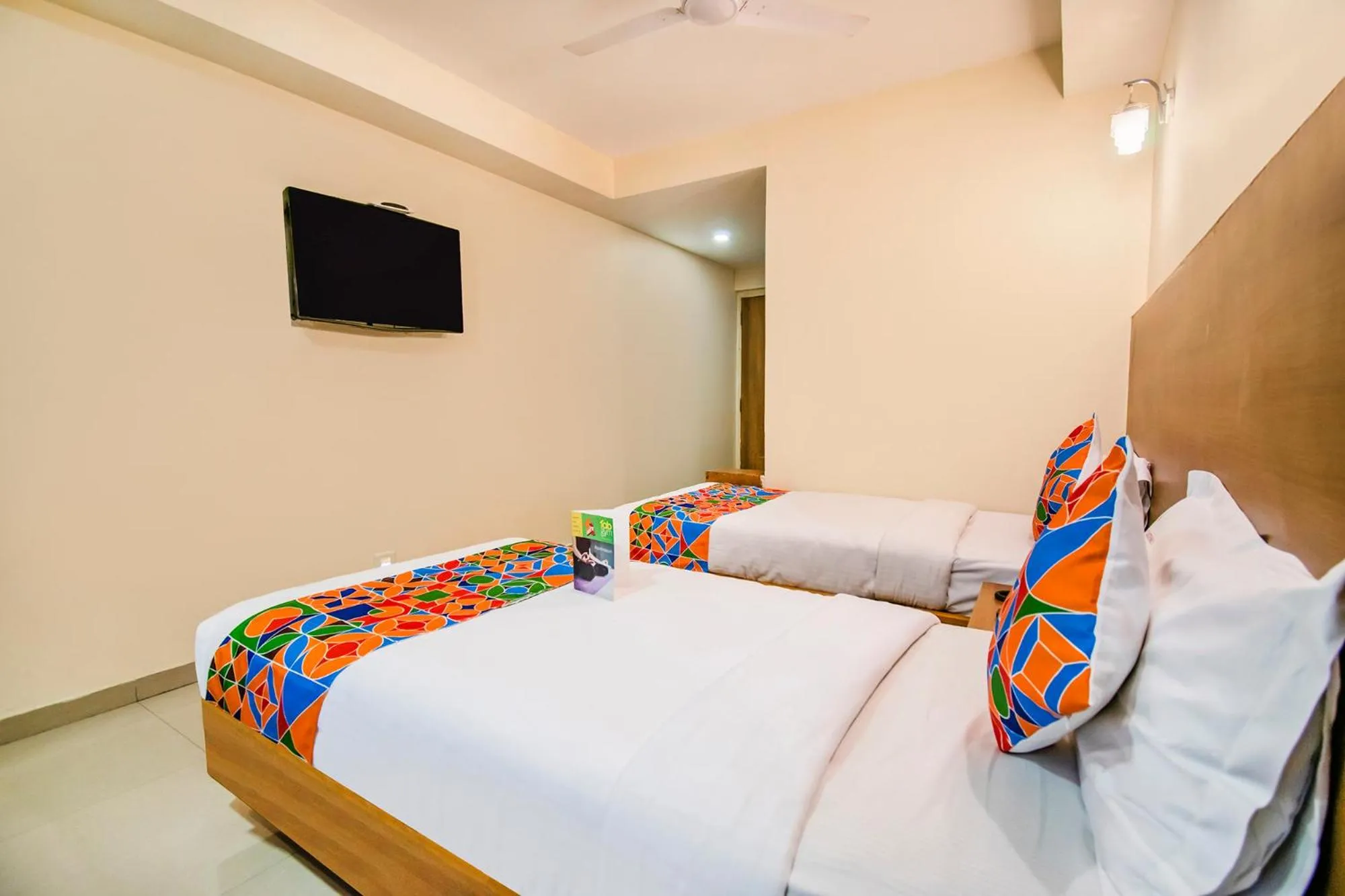 Bed in FabHotel Jansi Deluxe - Nr Gandhipuram Bus stand