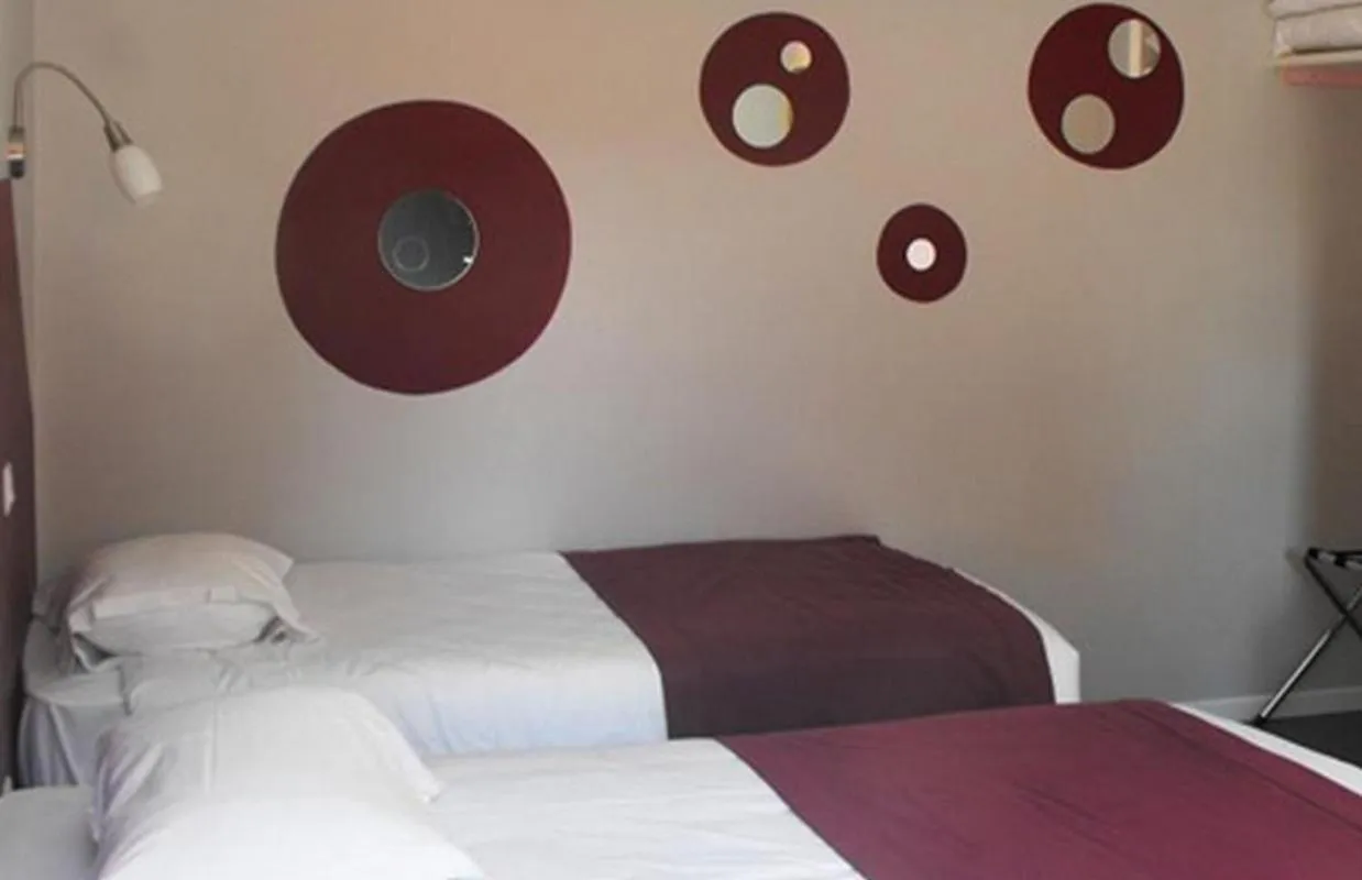 Photo of the whole room, Bed in Logis Hôtel Restaurant Les Capucins