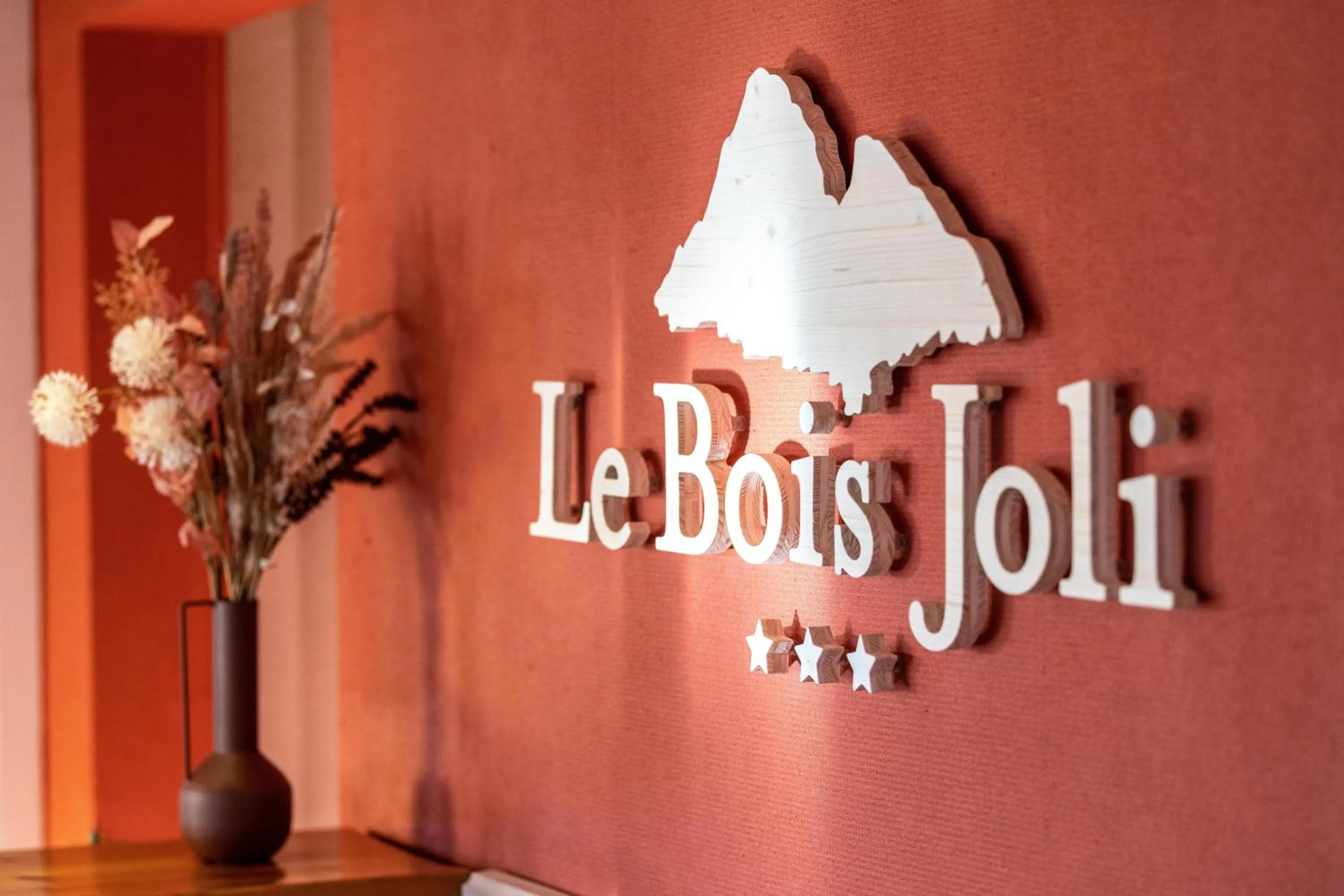 Property logo or sign in Hotel Le Bois Joli