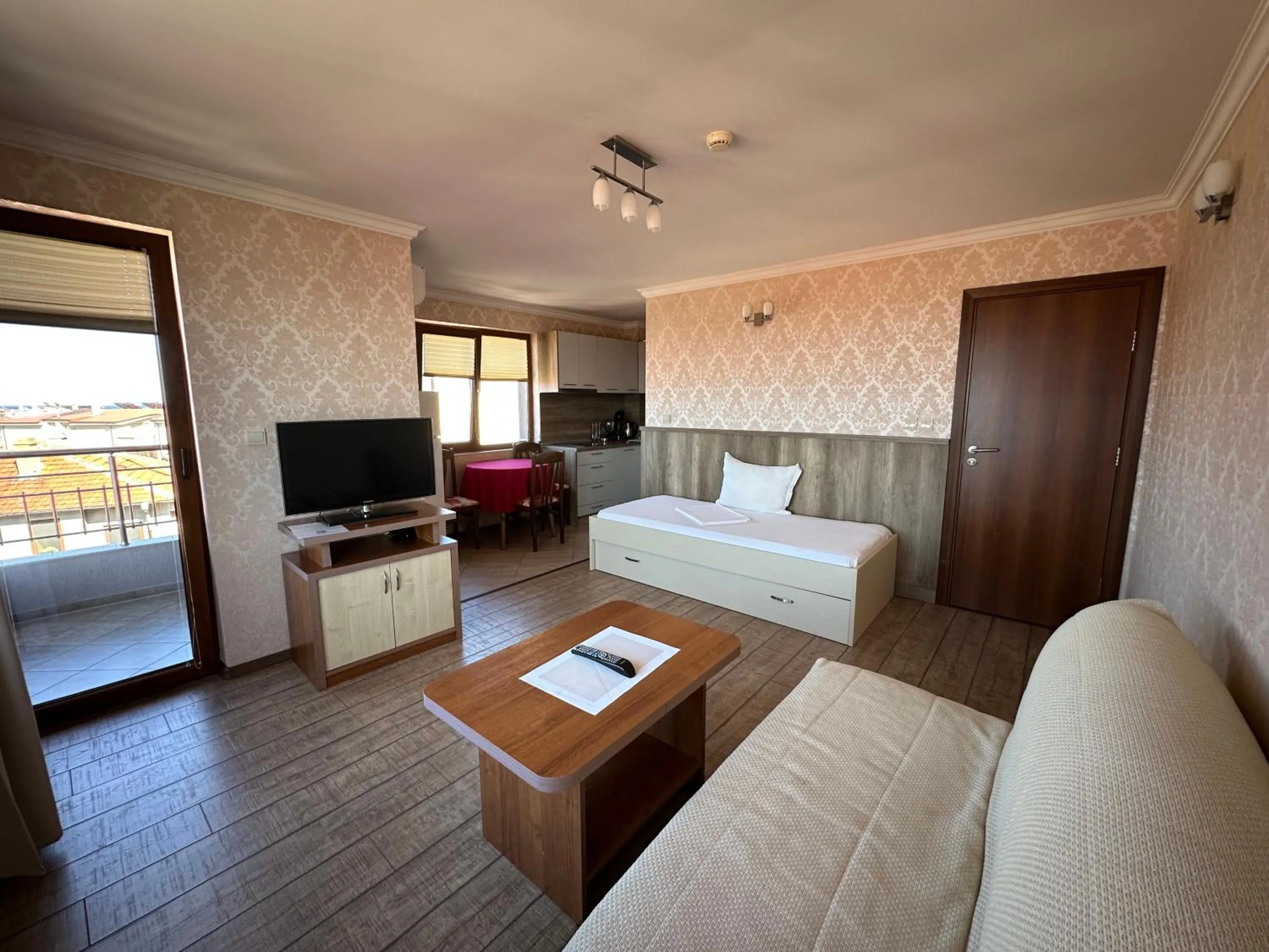 Communal lounge/ TV room, Bed in Family Hotel Radiana