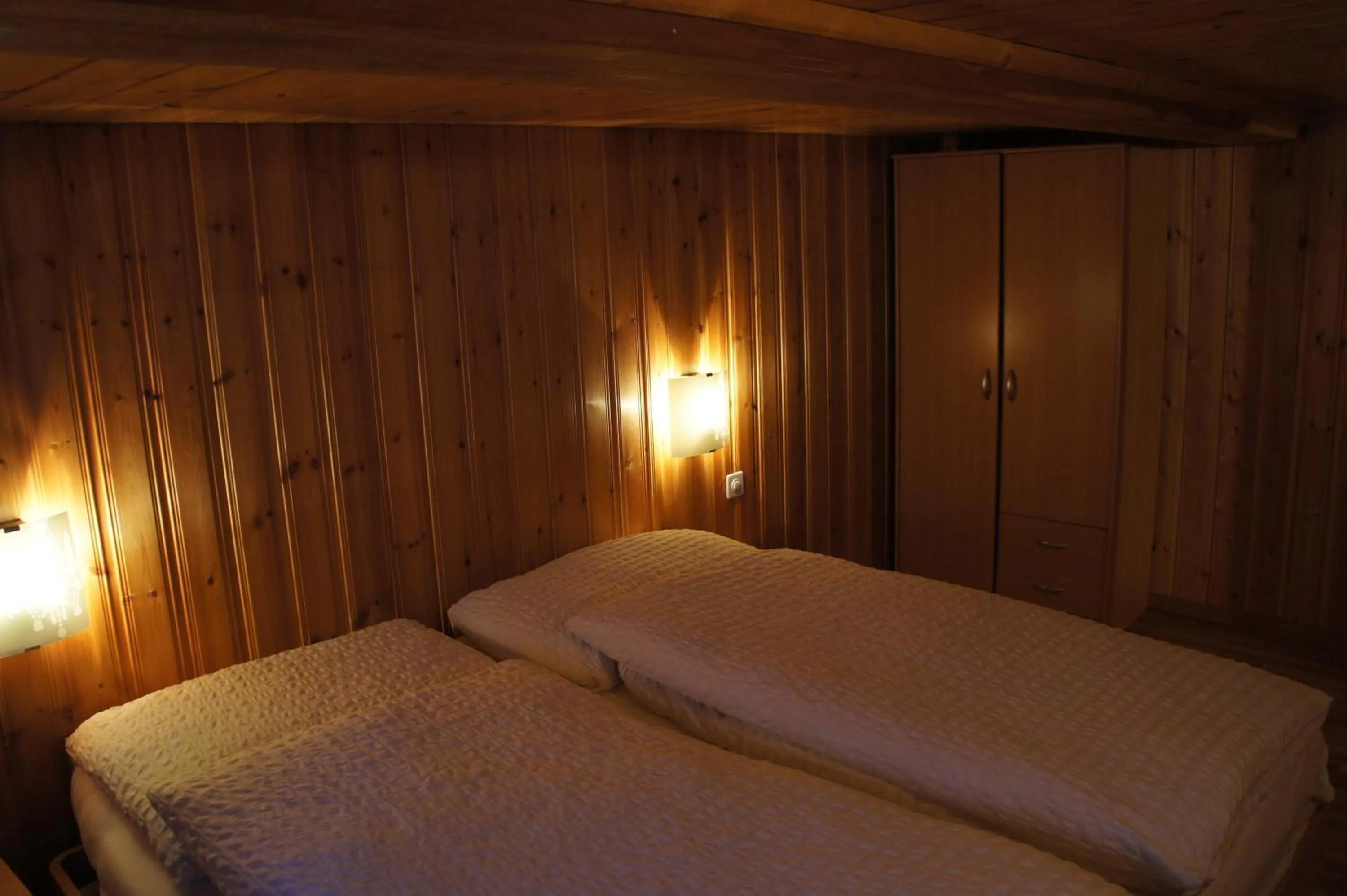 Bed in Petit Helvetia Budget Hotel