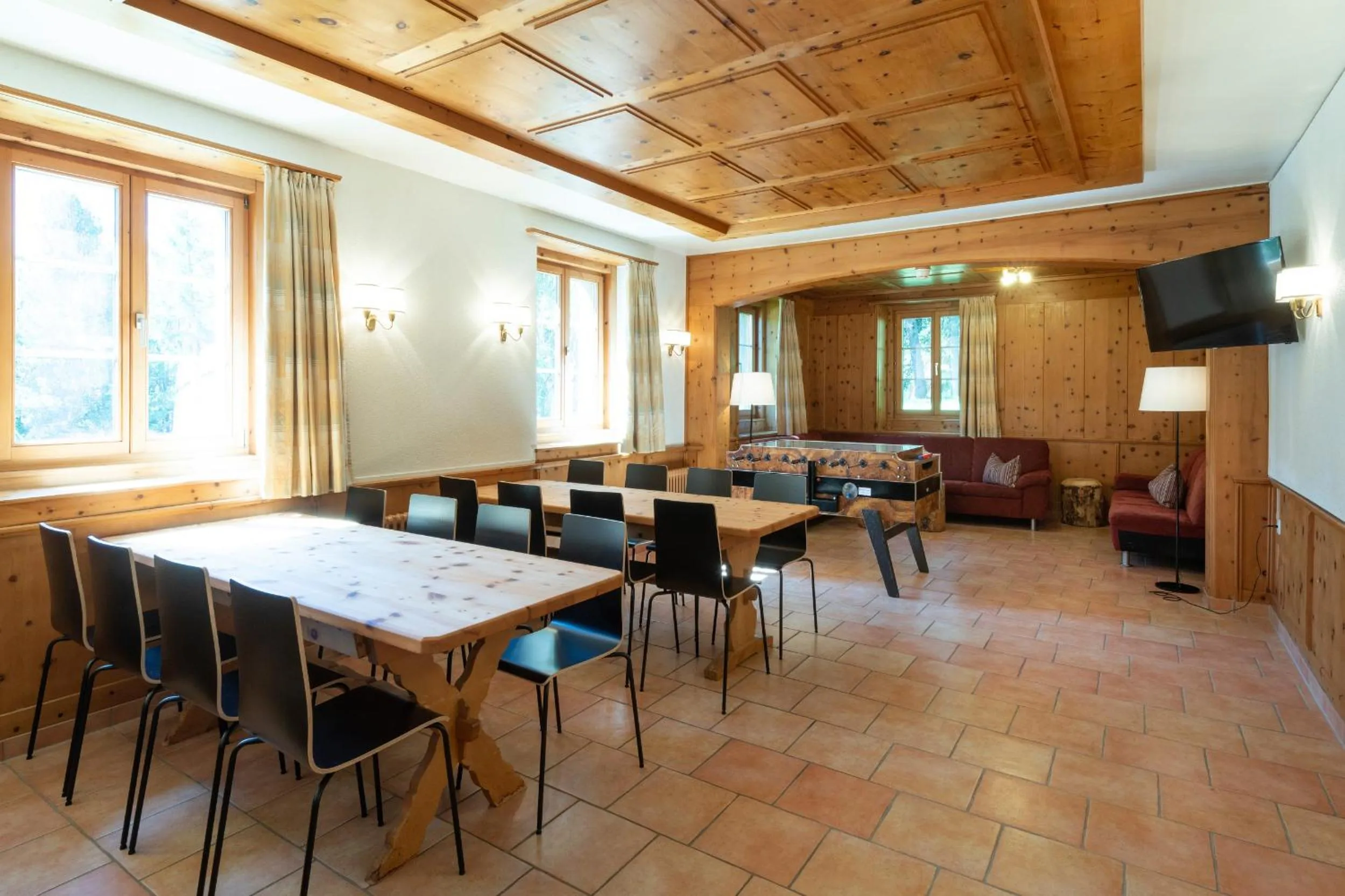 Communal lounge/ TV room in Hostel by Randolins