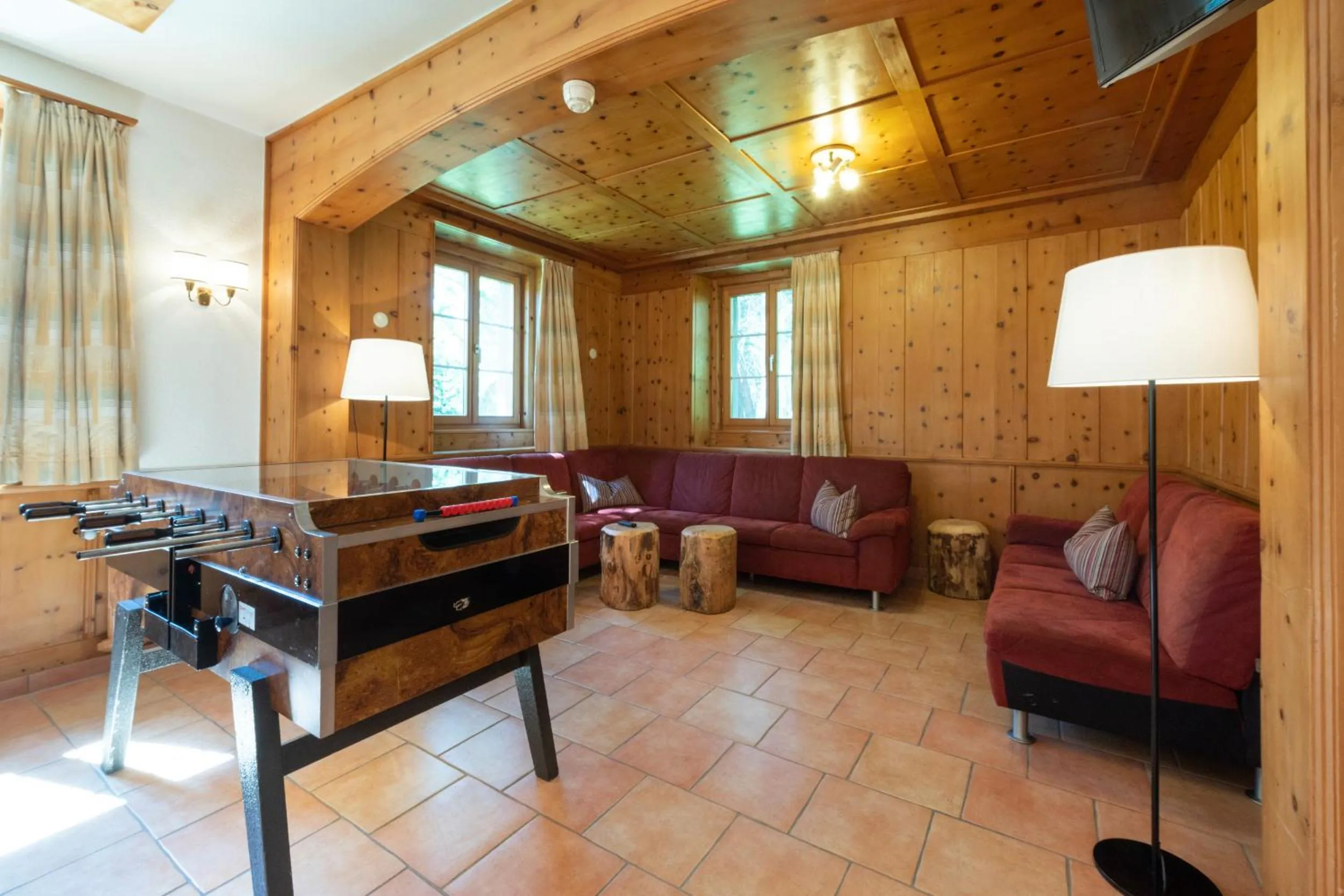 Communal lounge/ TV room in Hostel by Randolins