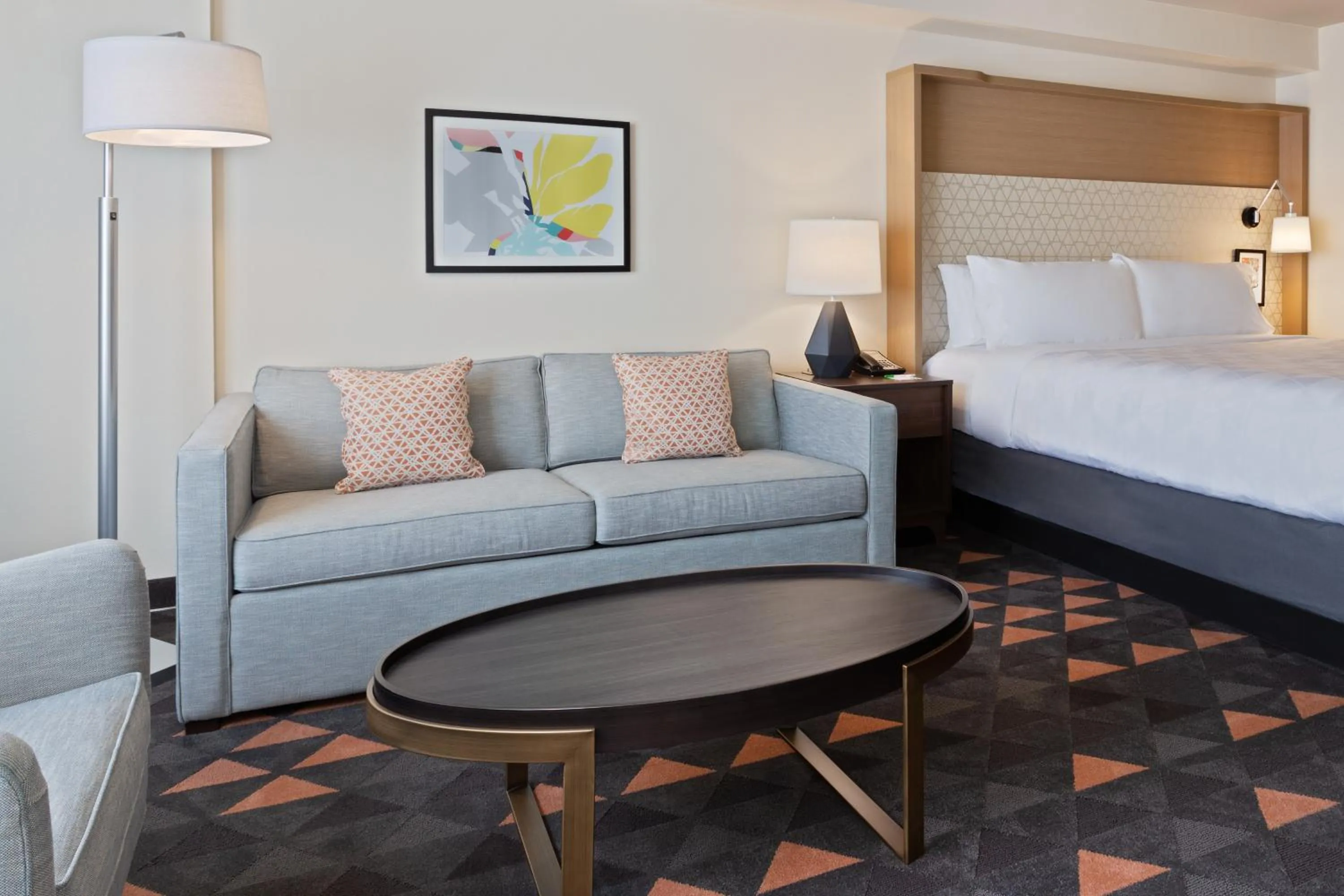 Seating area, Bed in Holiday Inn & Suites Across from Universal Orlando by IHG