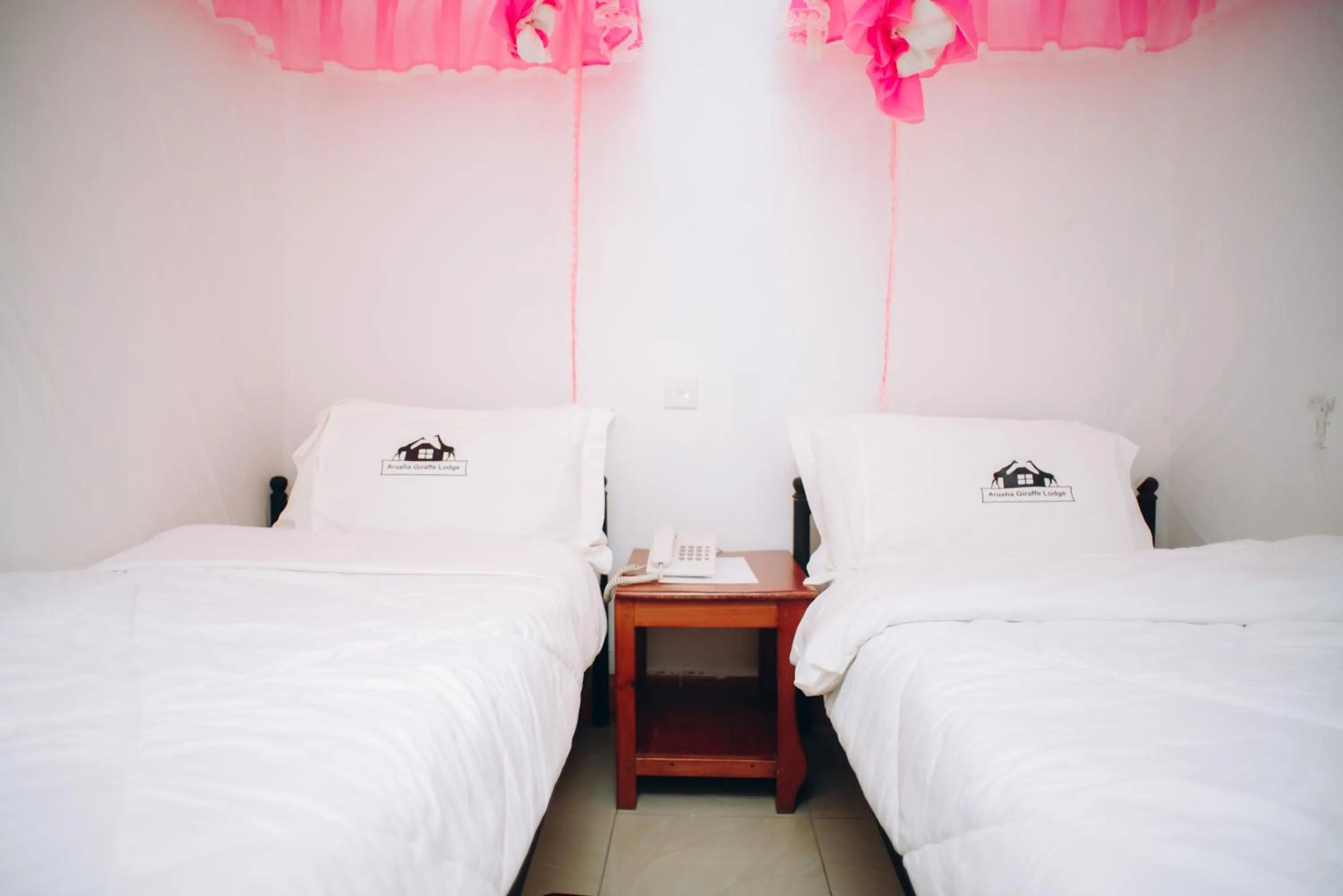 Bed in Arusha Giraffe Lodge