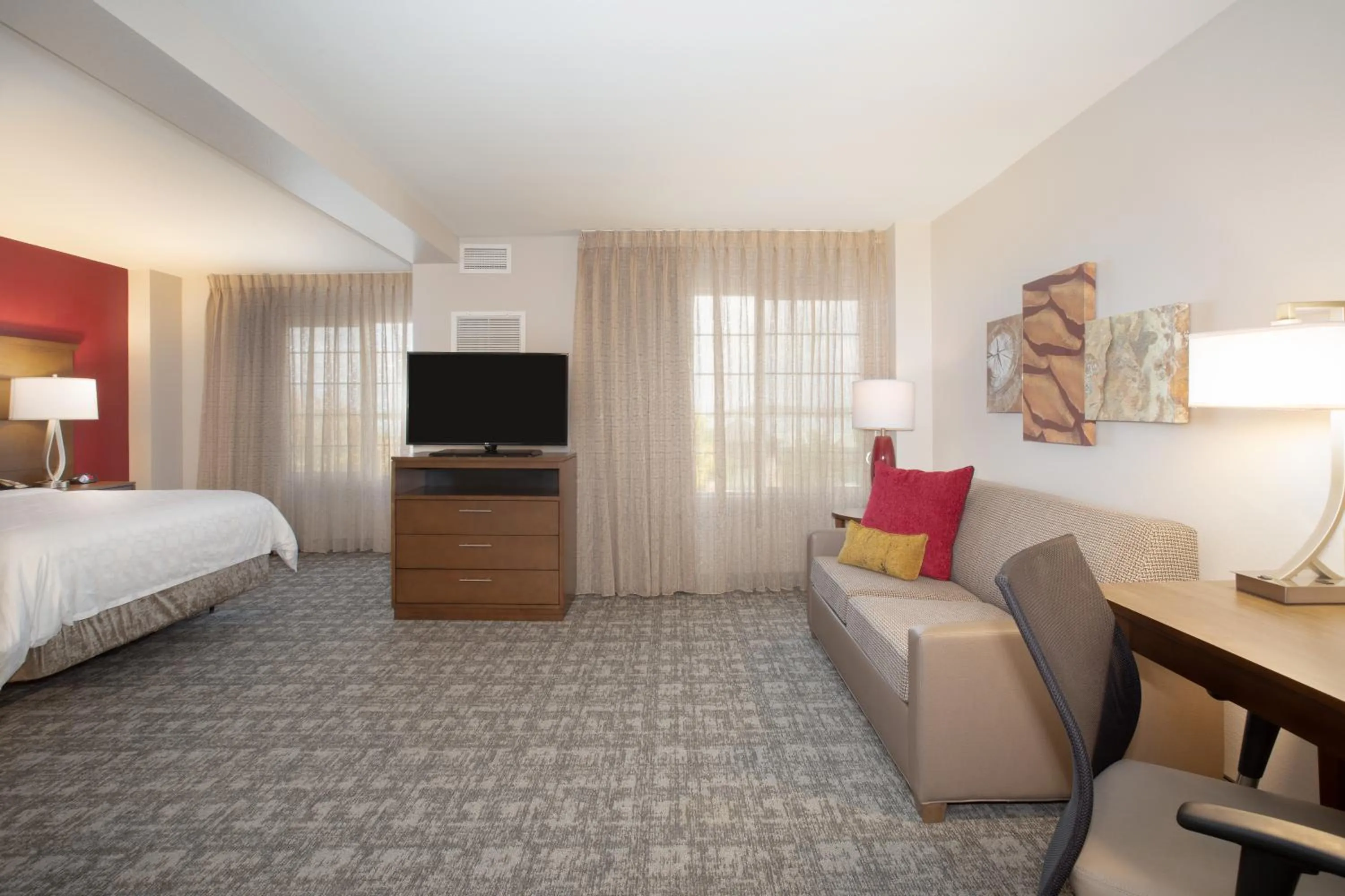 Seating area, Bed in Staybridge Suites Denver International Airport by IHG