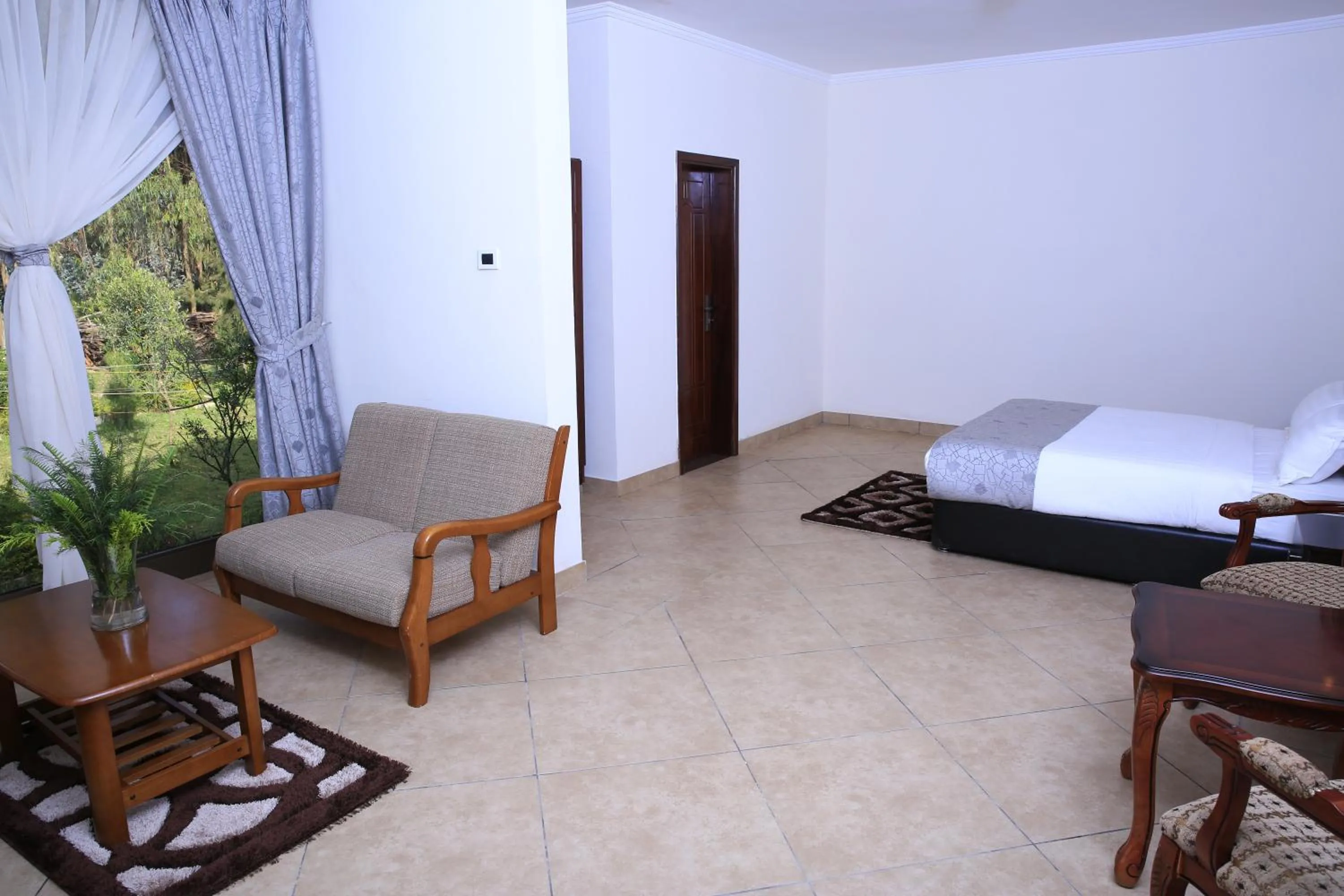 Seating area, Bed in Yaya Africa Athletics Village