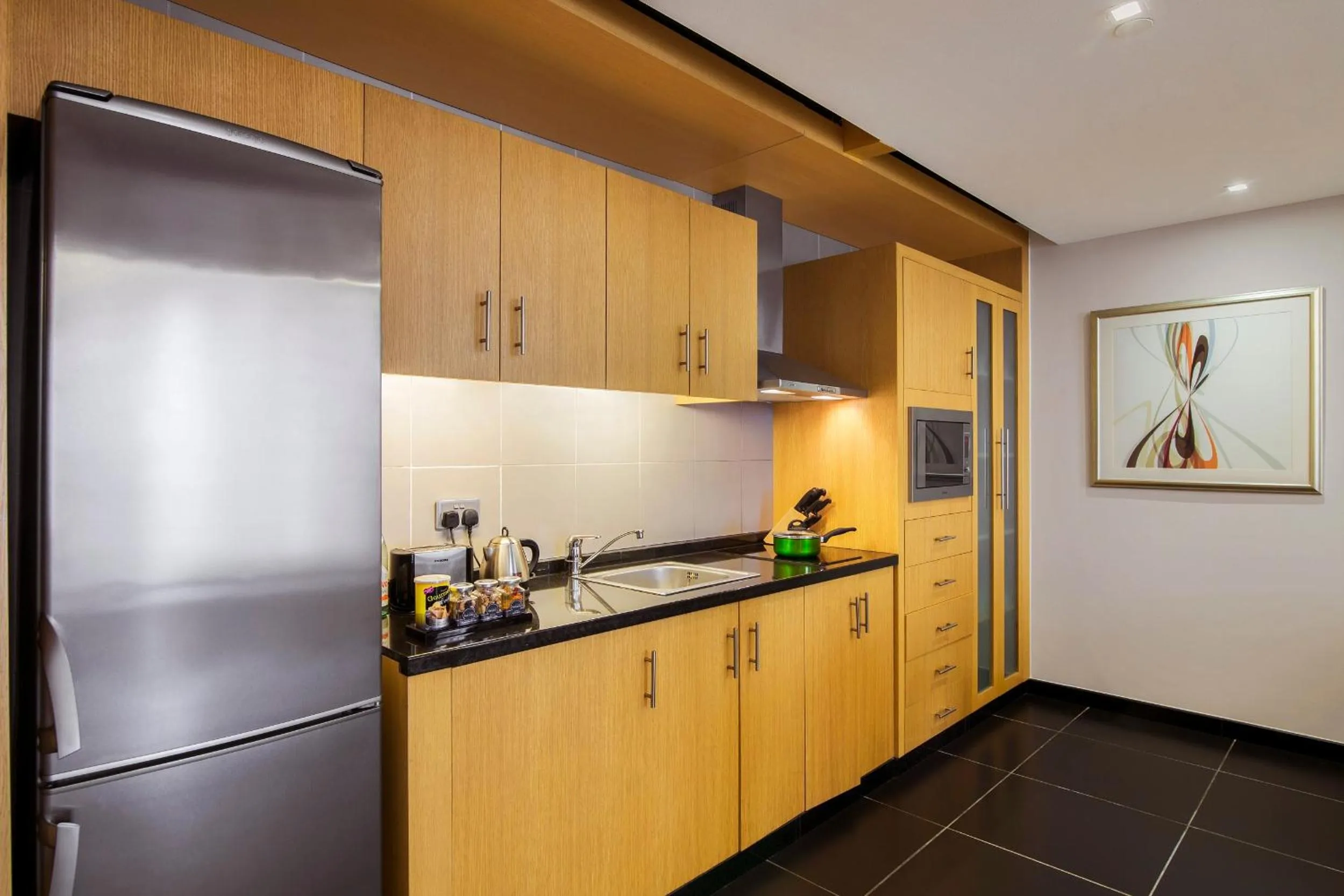 Kitchen or kitchenette in Hala Arjaan by Rotana, Deluxe Hotel Apartments