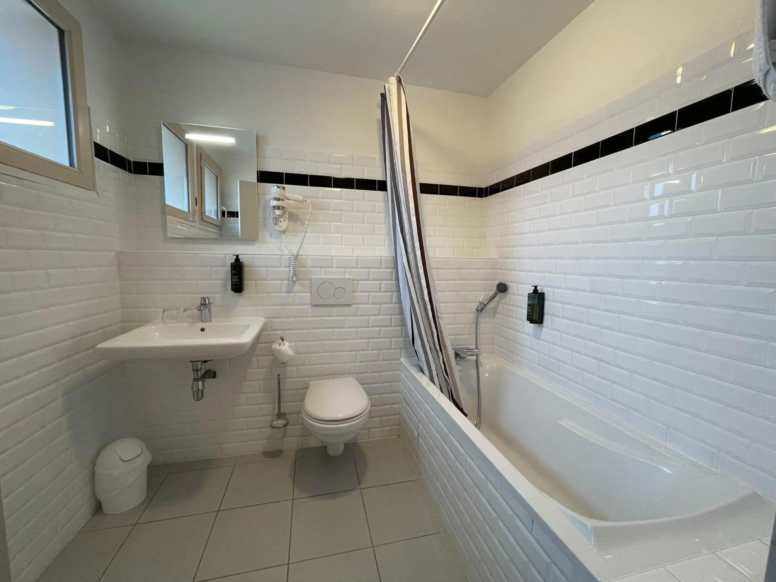 Bathroom in Logis Hôtels - Le Belvédère - Hôtel 2 étoiles et Restaurant