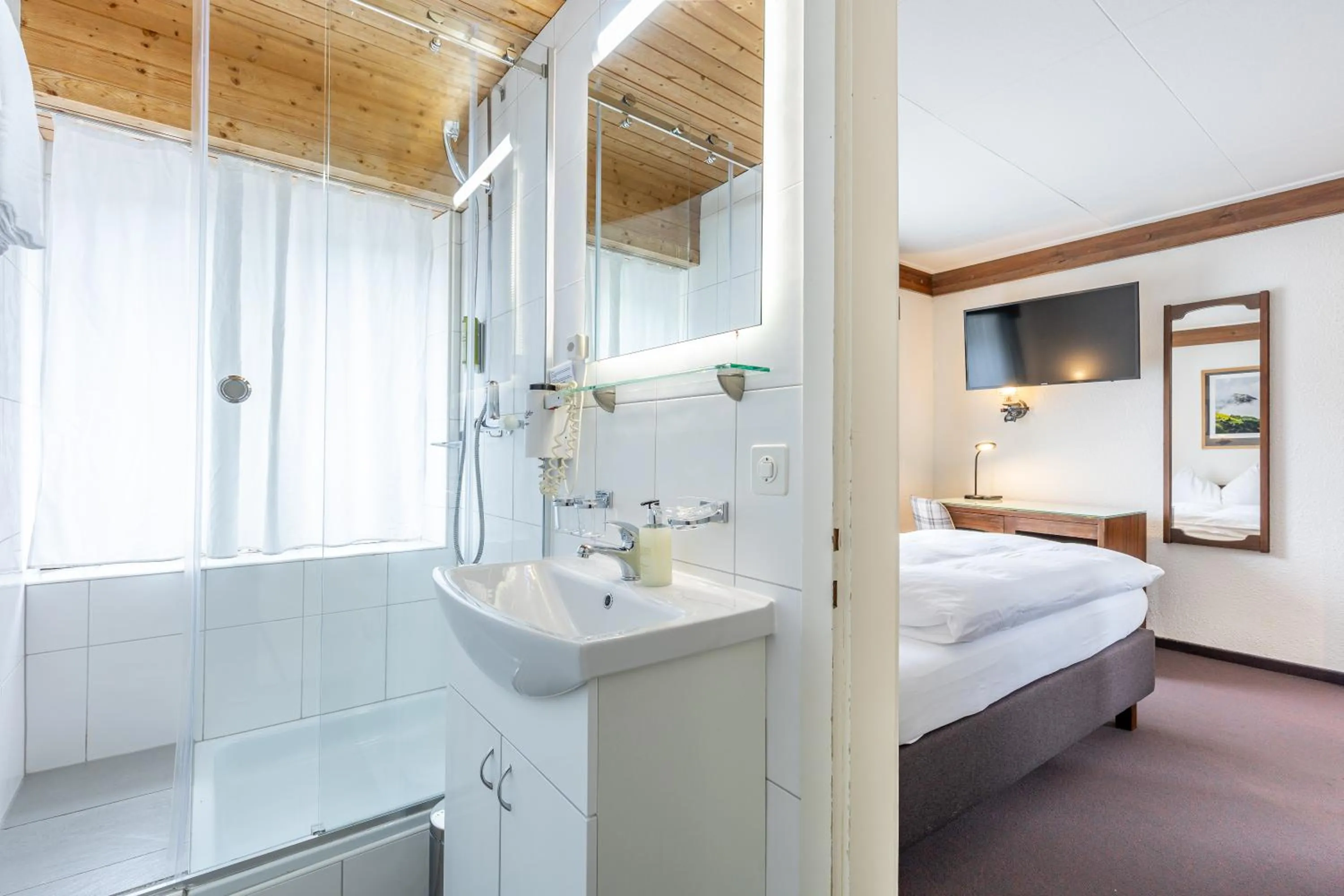 Bathroom, Bed in Hotel Dischma