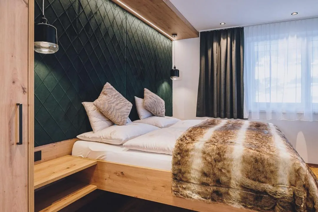 Bed in Dorfkrug Kaprun - Luxury Suites & Appartements