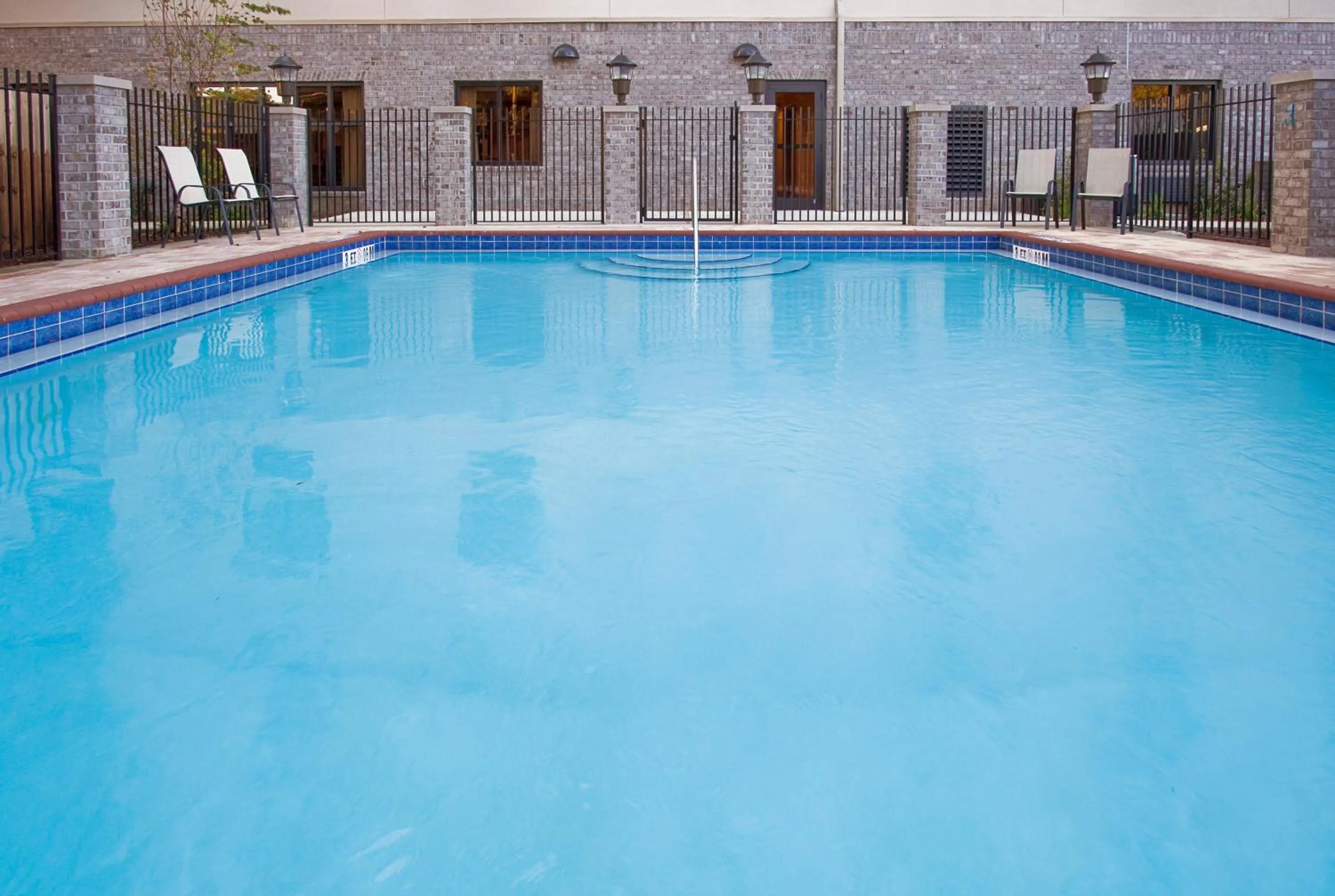Swimming pool in Holiday Inn Express Hotel & Suites Pensacola-West Navy Base by IHG