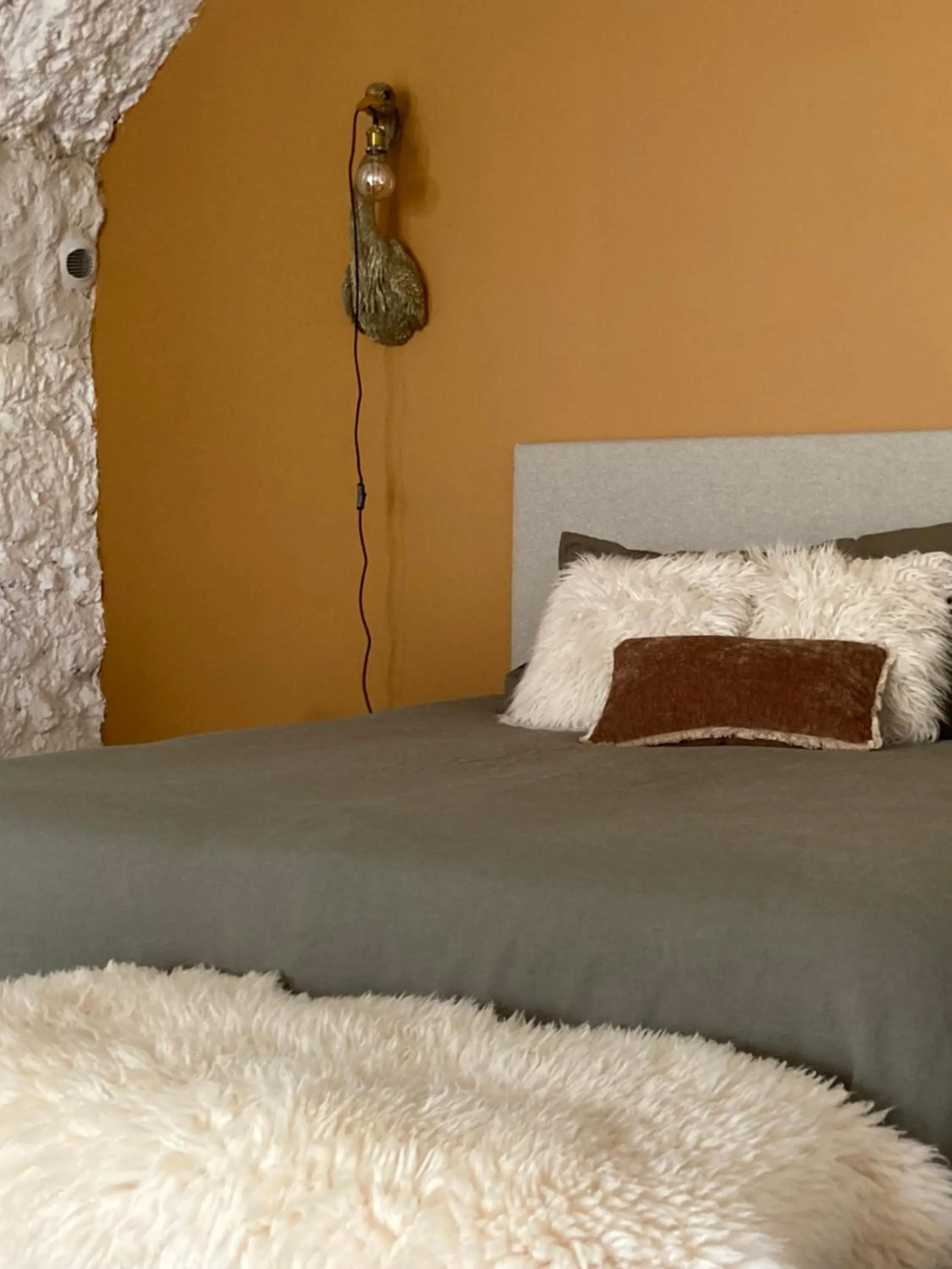 Bed in Les Troglos de la Tufolière