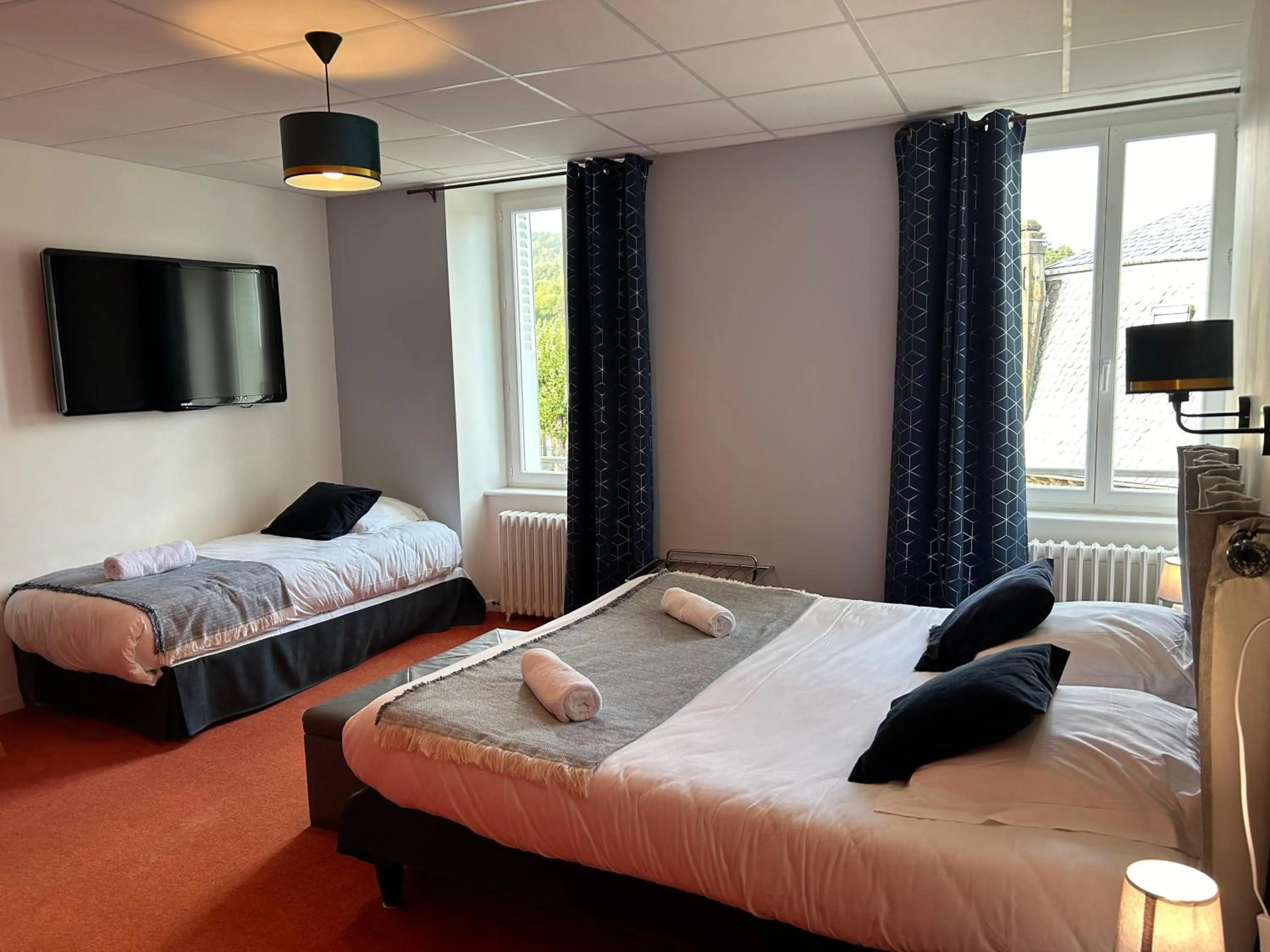 Bed in Logis Hôtel de Paris