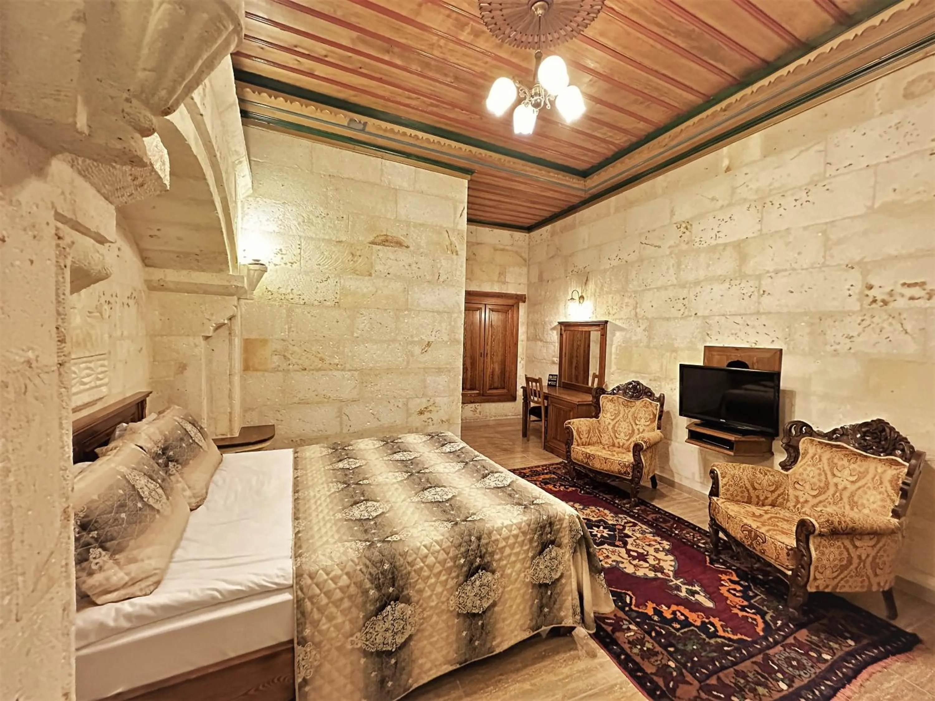 Bed in Stone House Cave Hotel