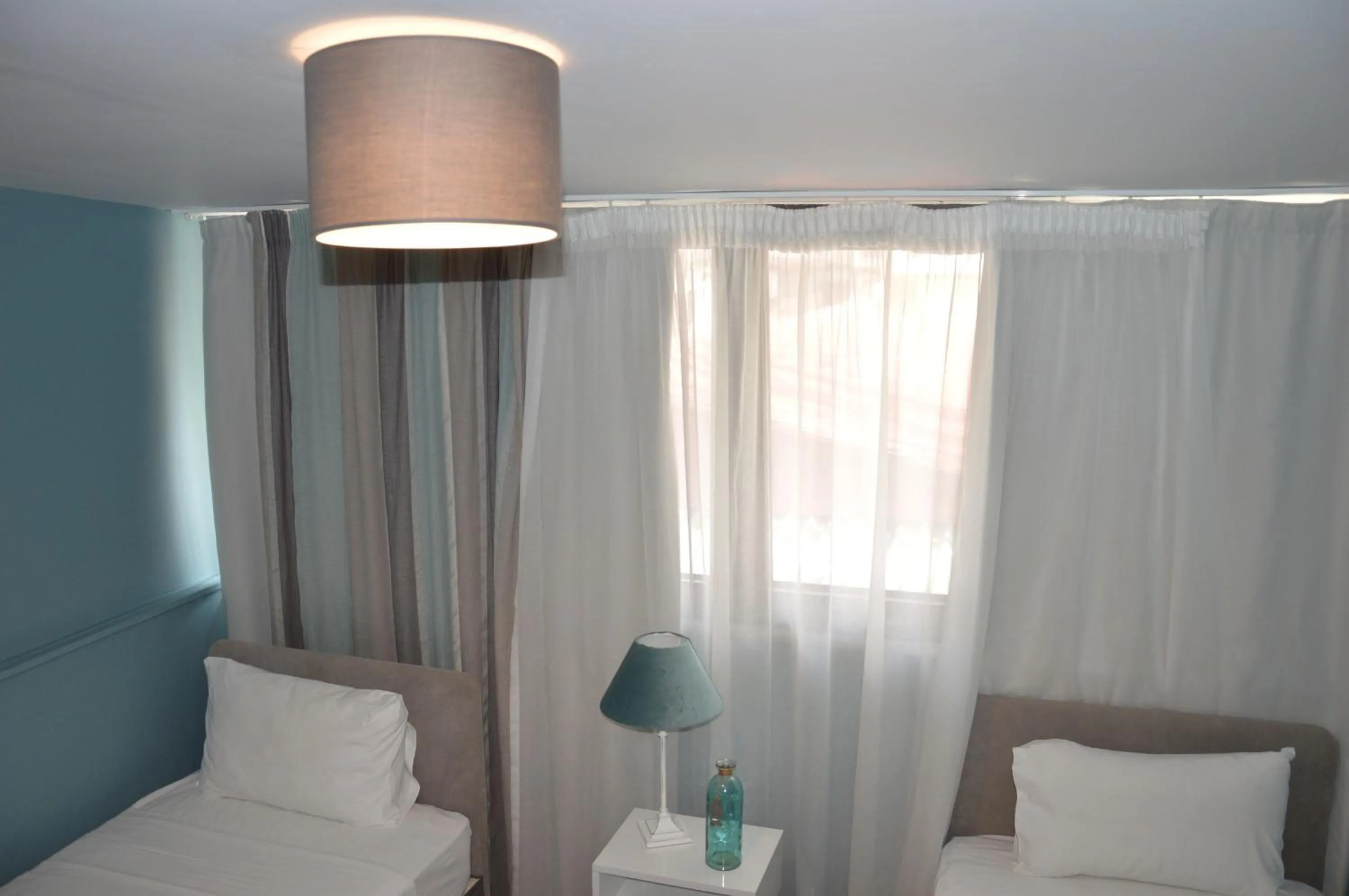 Bed in Aqua Mare Sea Side Rooms