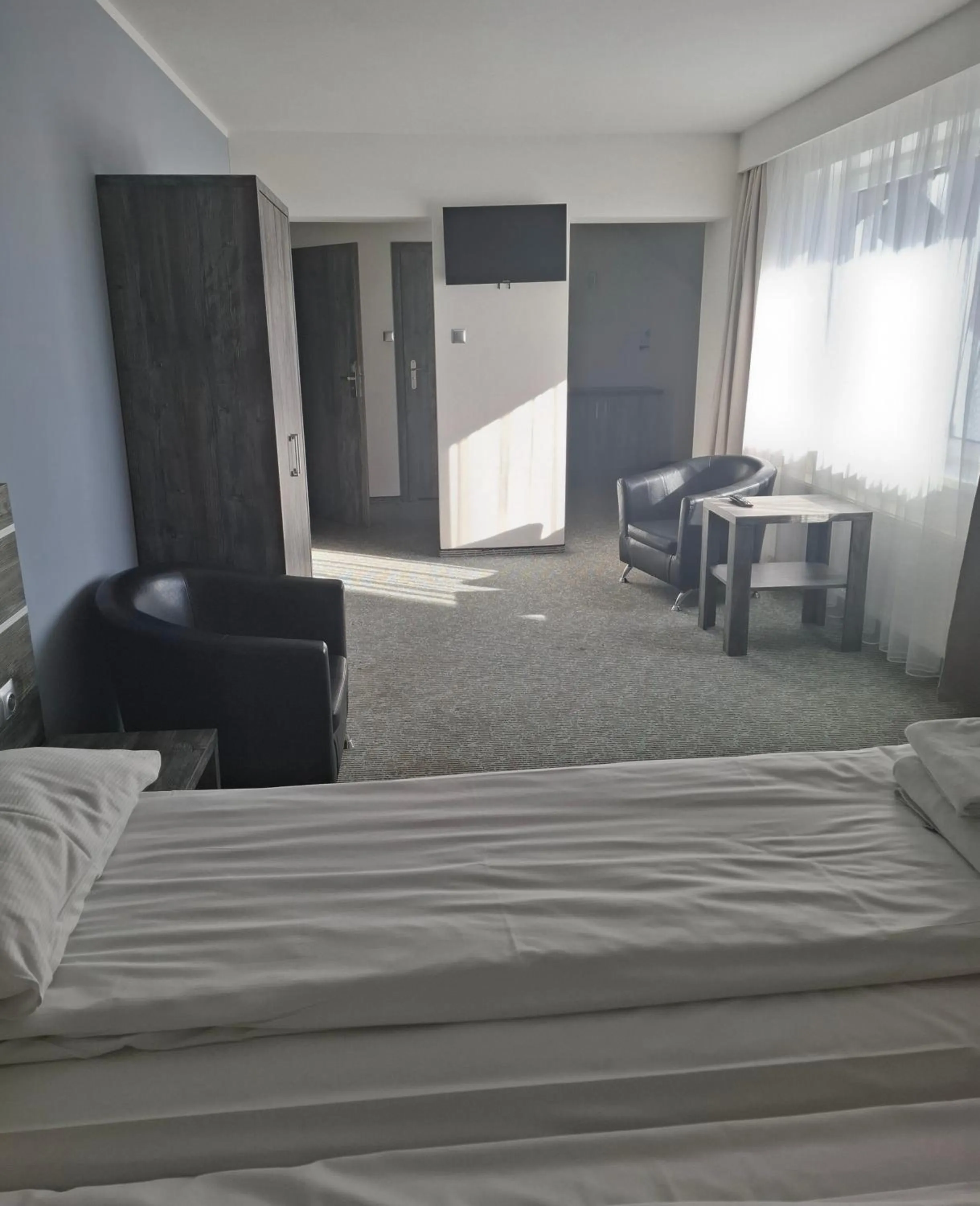 Seating area, Bed in Hotel Giżycko