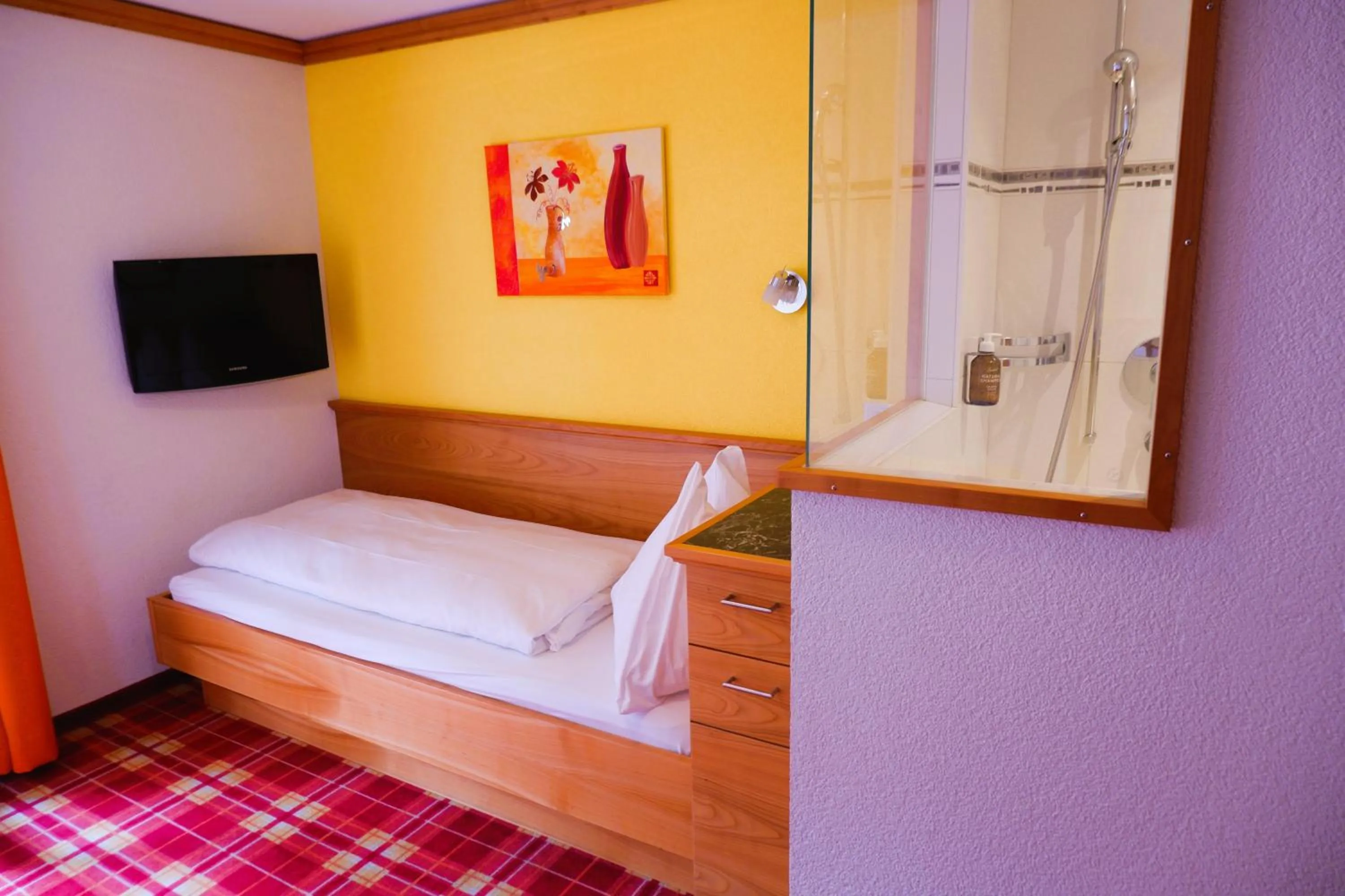 Bed in Hotel Christiania Saas-Fee