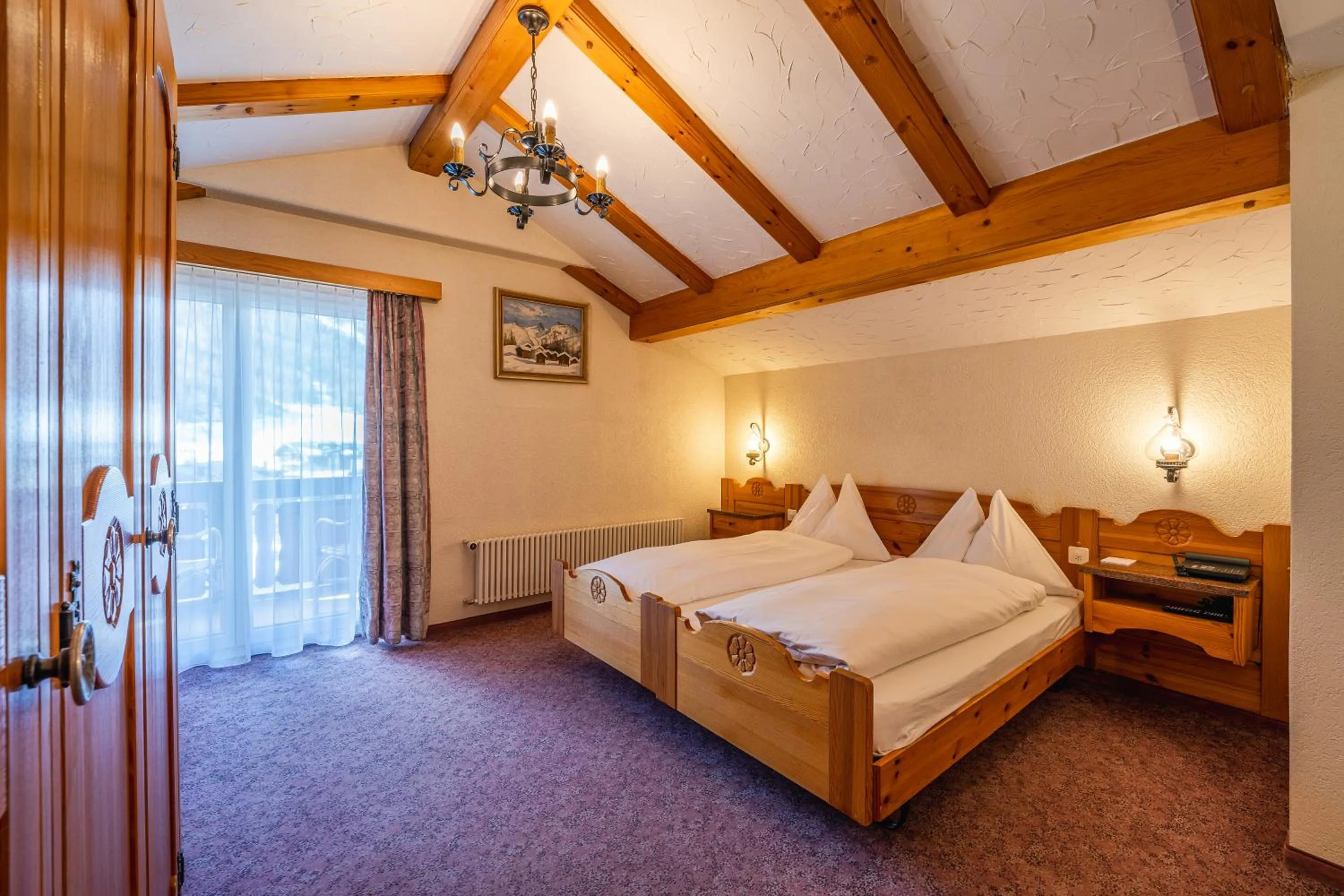 Bed in Hotel Christiania Saas-Fee