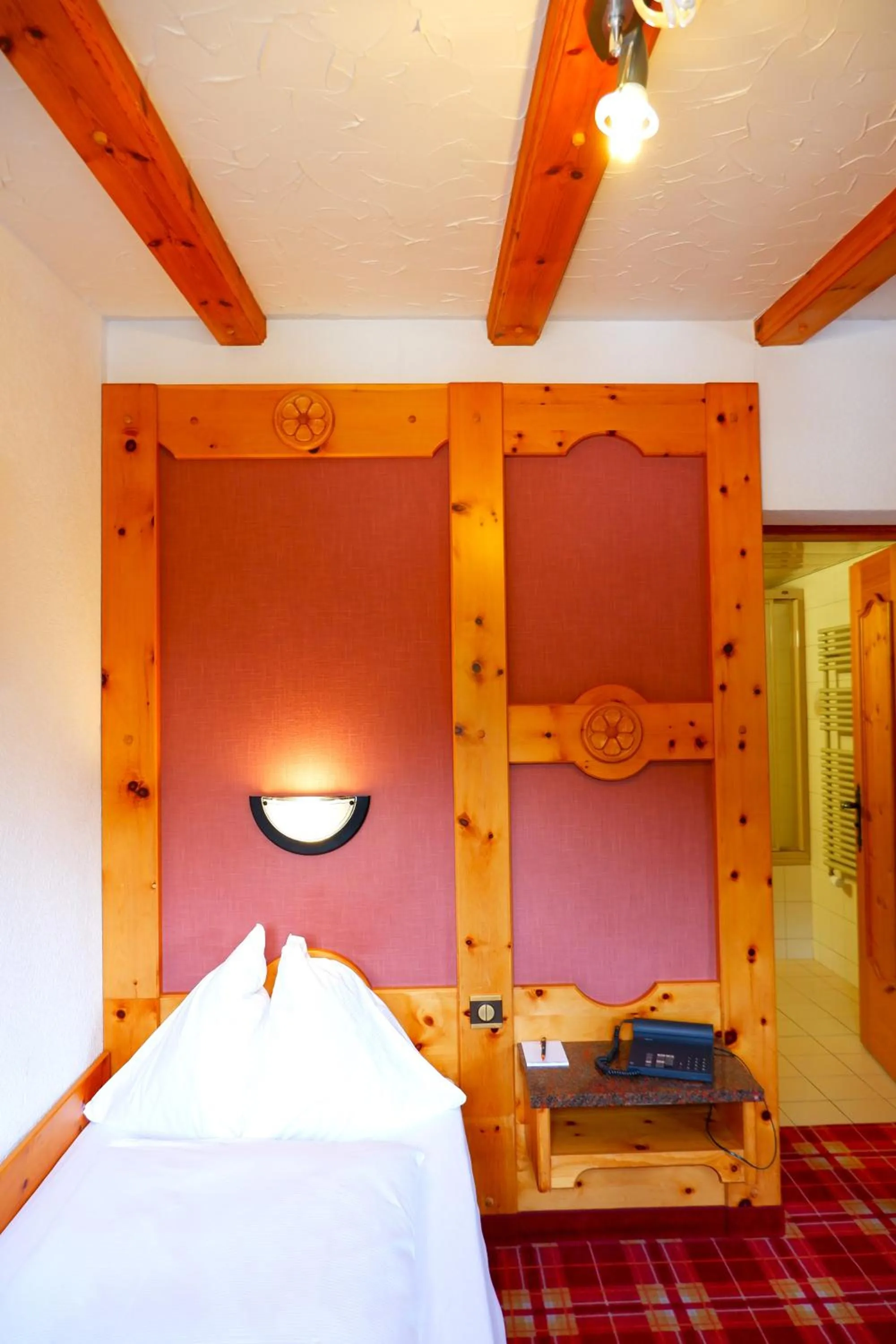 Bed in Hotel Christiania Saas-Fee