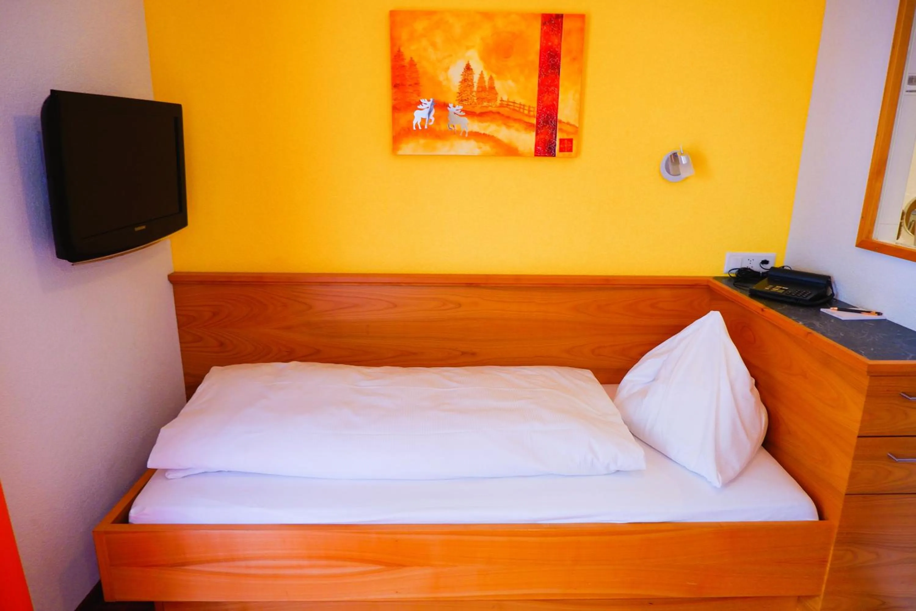 Bed in Hotel Christiania Saas-Fee