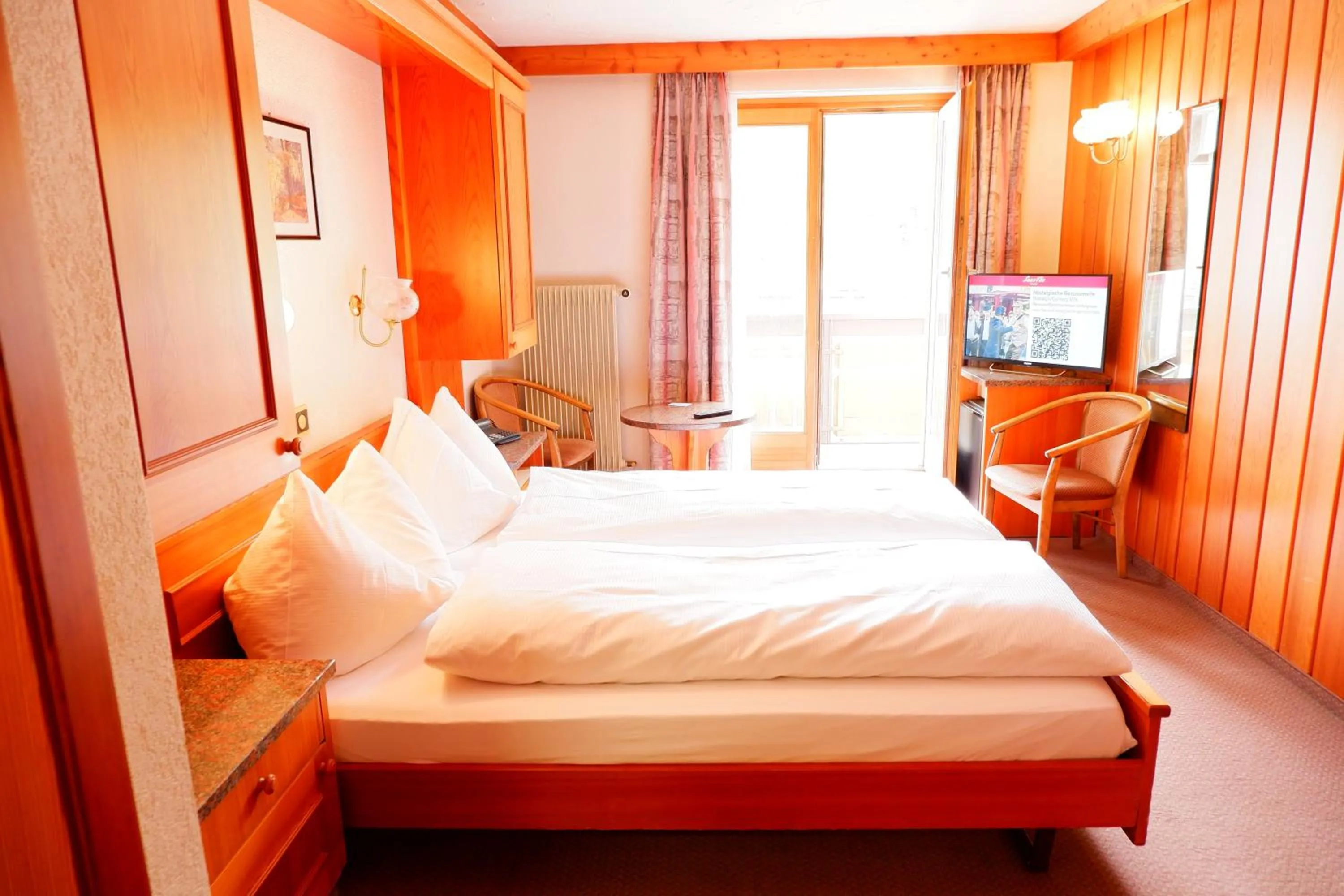 Bed in Hotel Christiania Saas-Fee