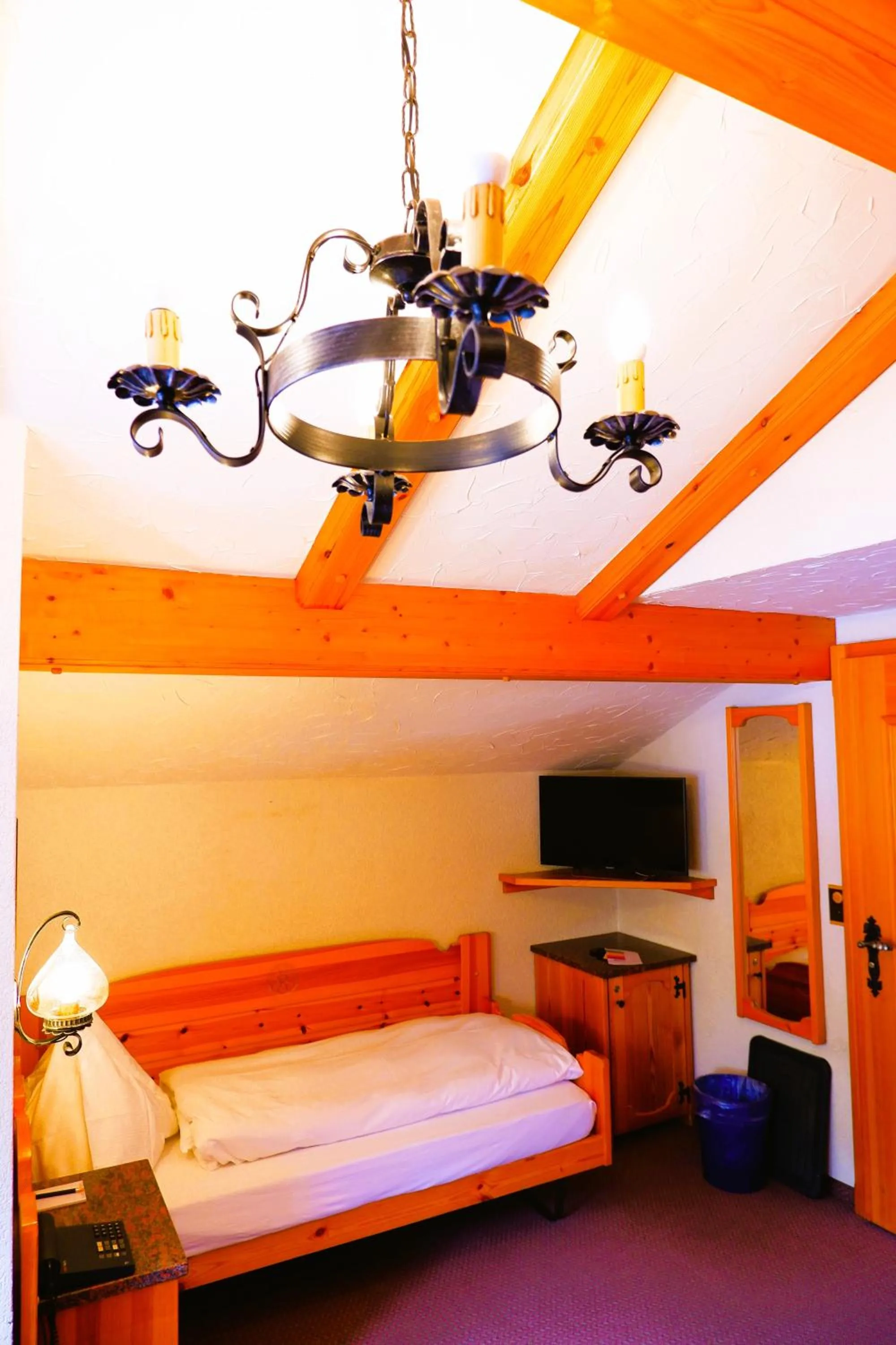 Bed in Hotel Christiania Saas-Fee