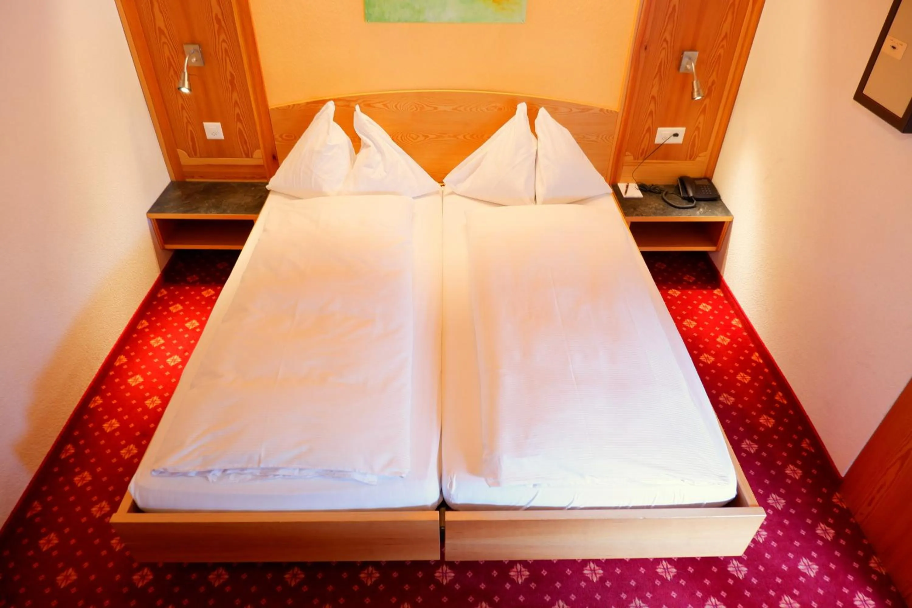 Bed in Hotel Christiania Saas-Fee