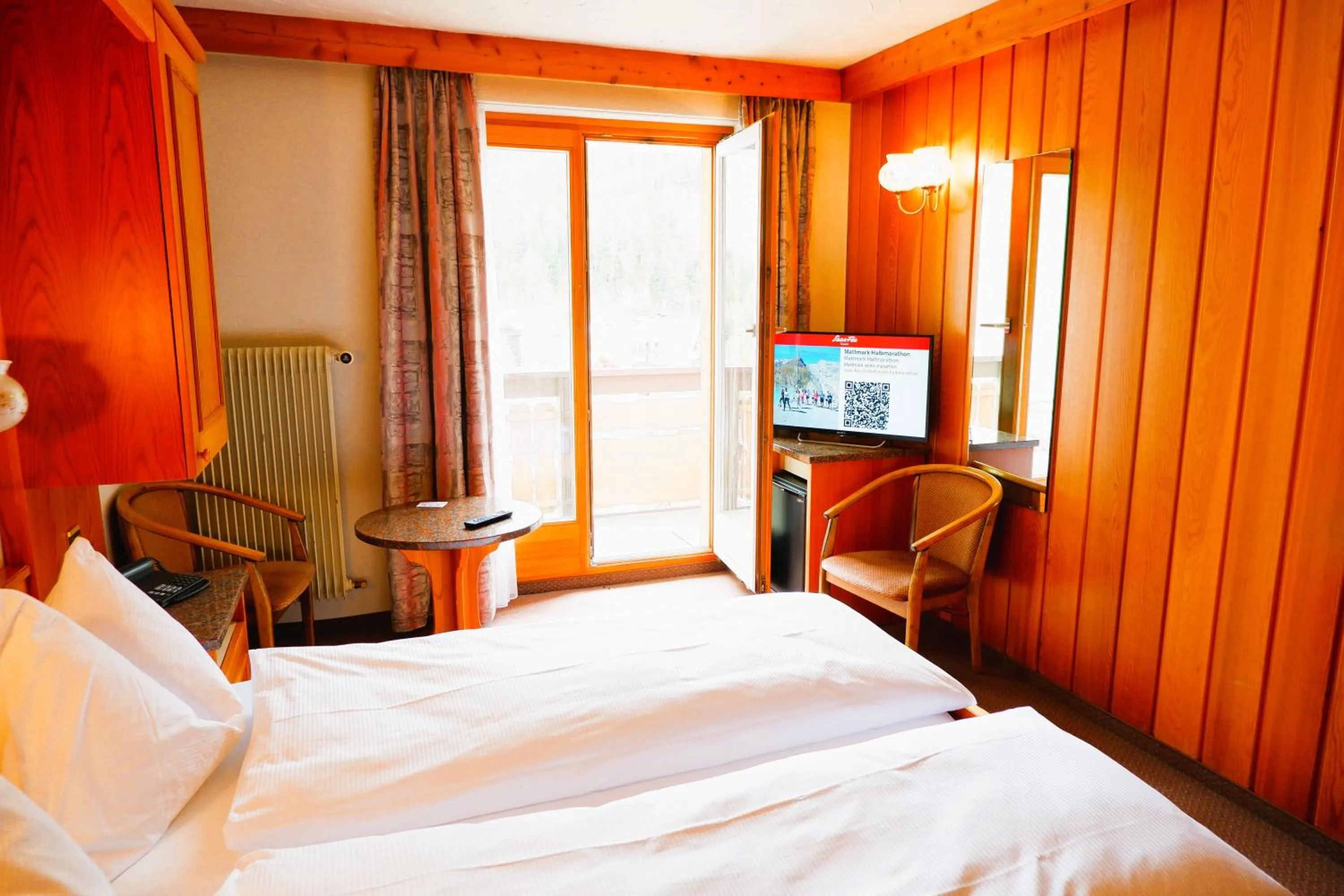 Bed in Hotel Christiania Saas-Fee