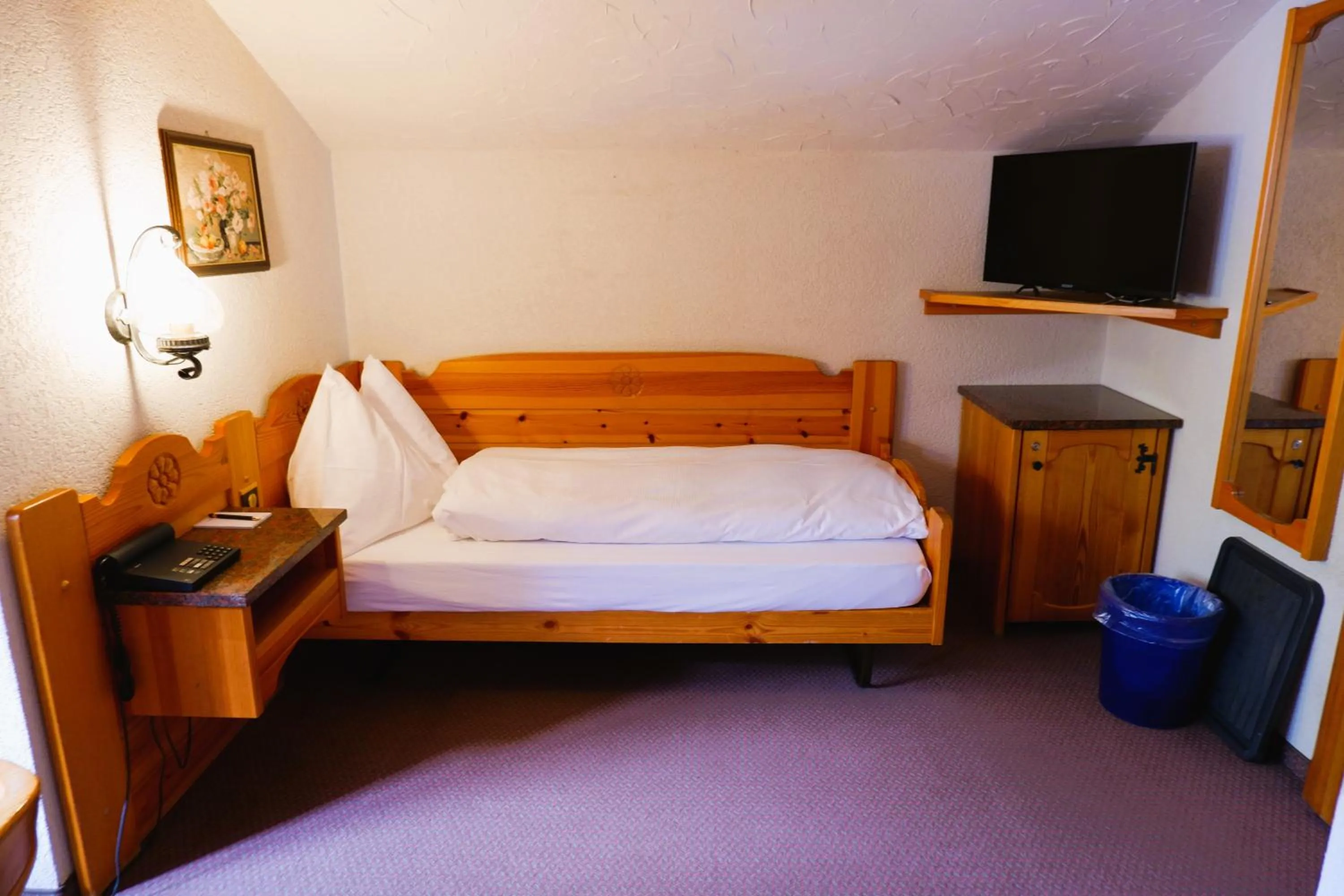 Bed in Hotel Christiania Saas-Fee