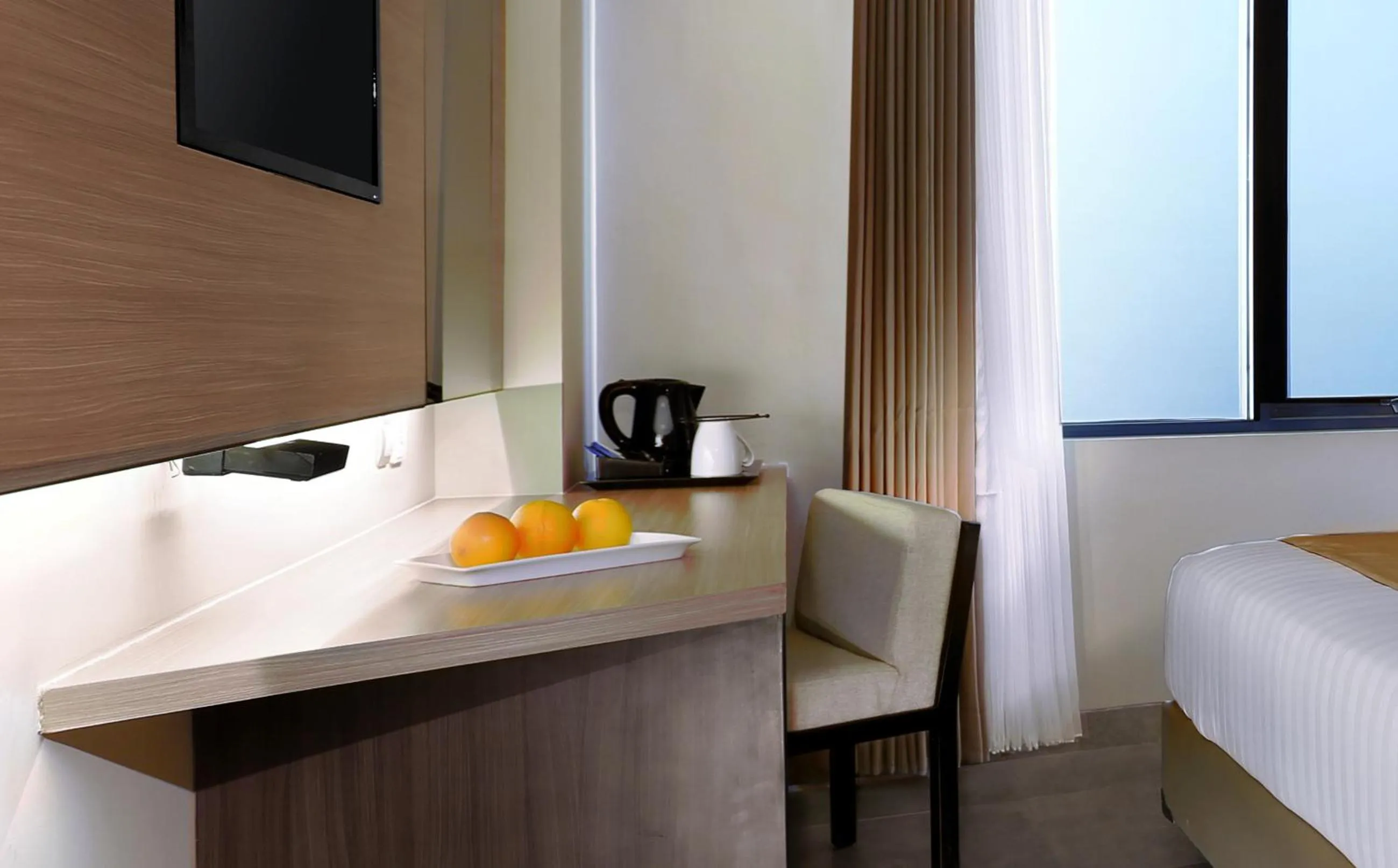 Seating area, Bed in Aston Inn Mataram