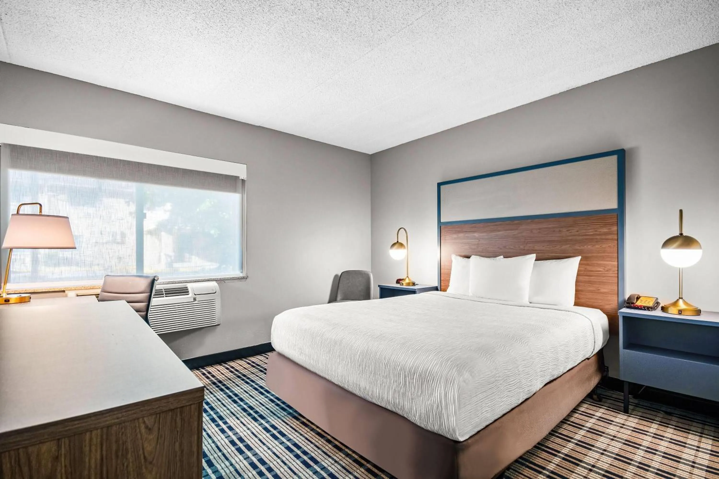 Bed in AmericInn by Wyndham Beloit