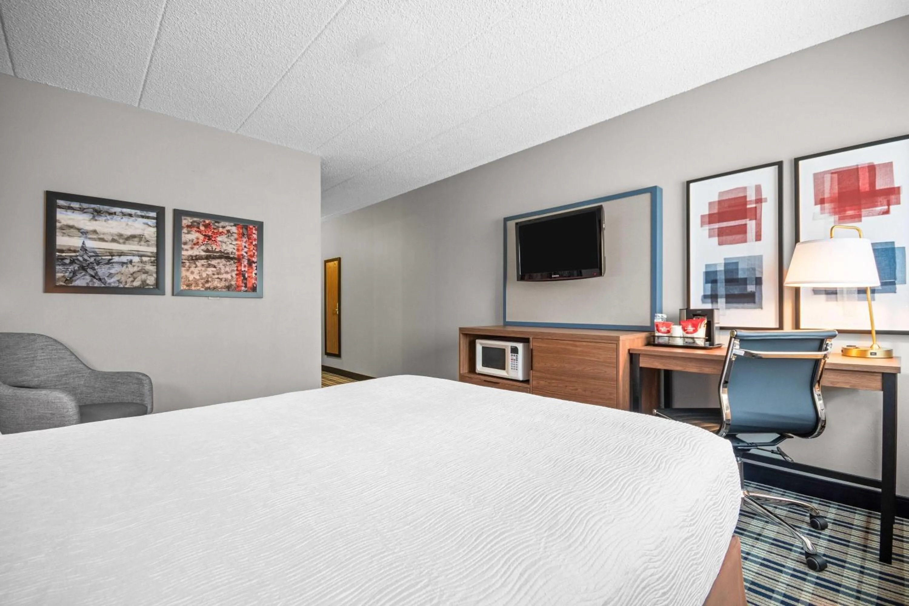 Bed in AmericInn by Wyndham Beloit