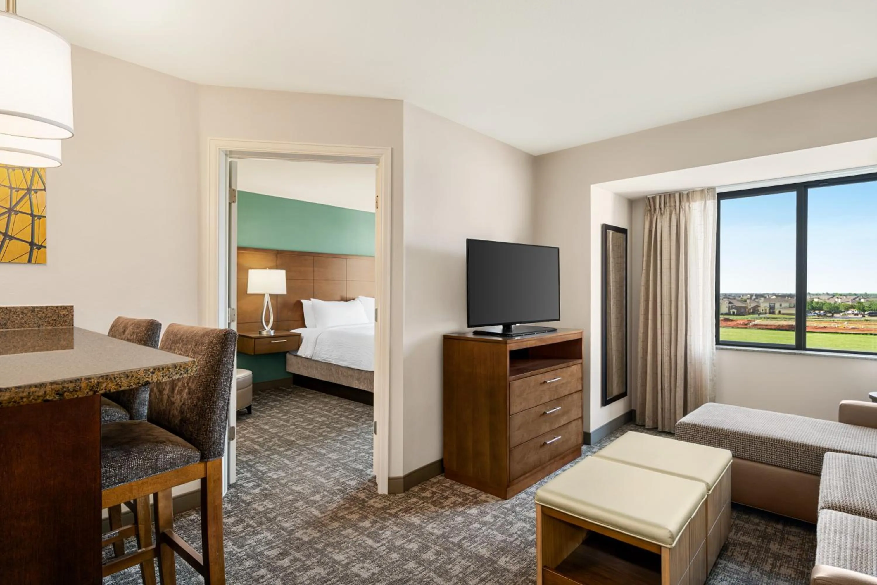 Living room, Bed in Staybridge Suites Oklahoma City-Quail Springs by IHG