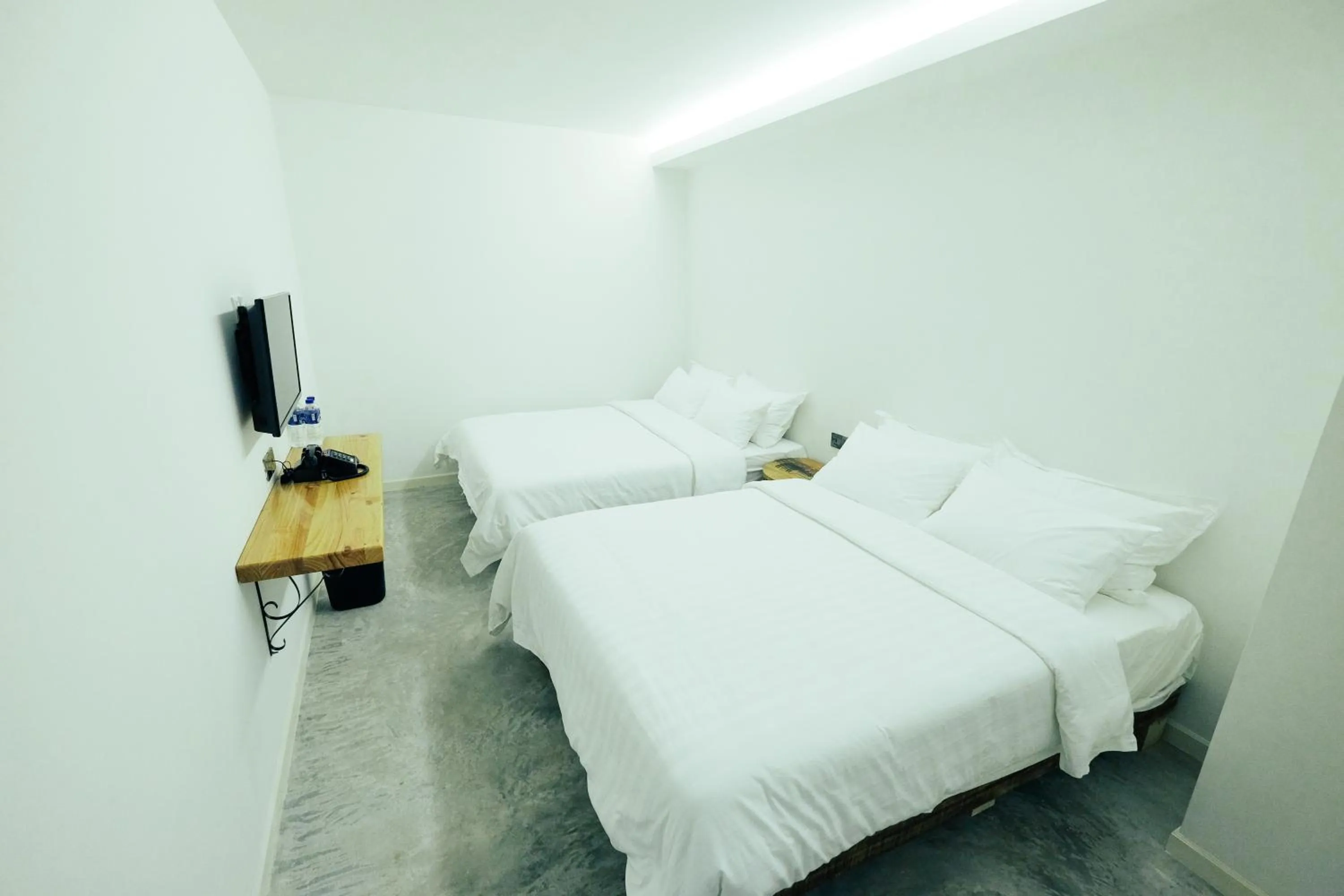 Bed in White Loft Hotel