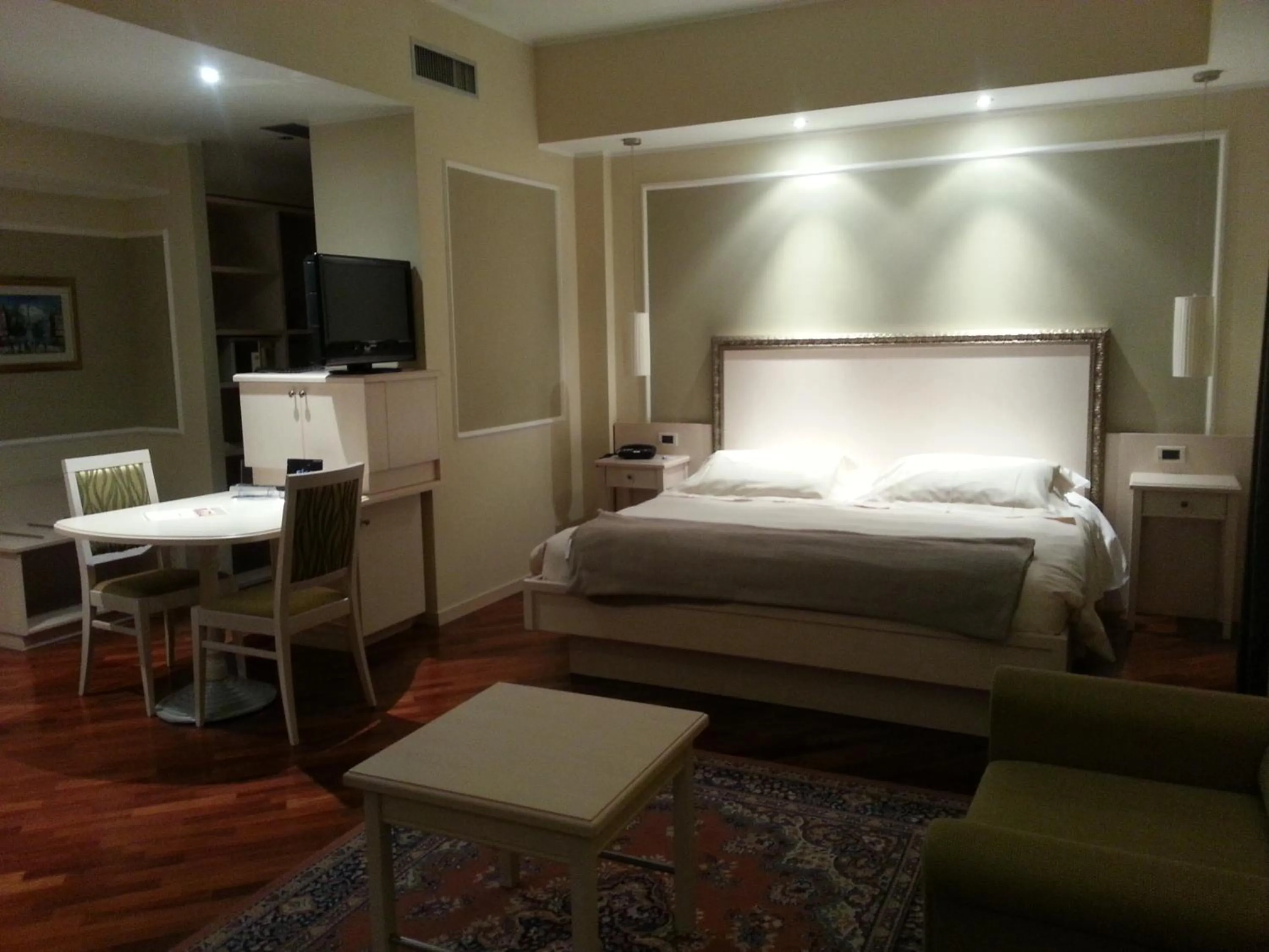 Seating area, Bed in Albergo Della Roccia