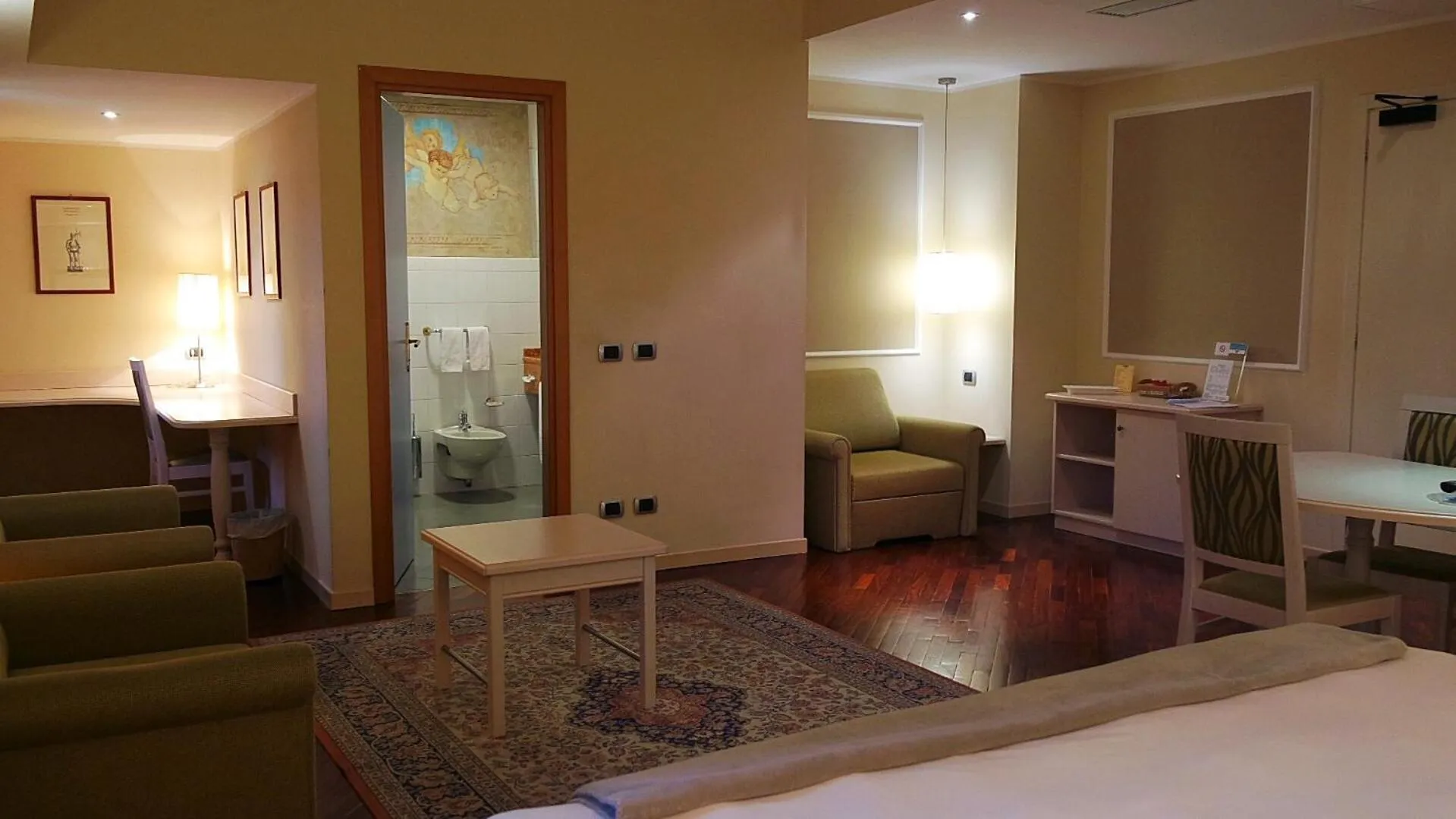 Seating area, Bed in Albergo Della Roccia