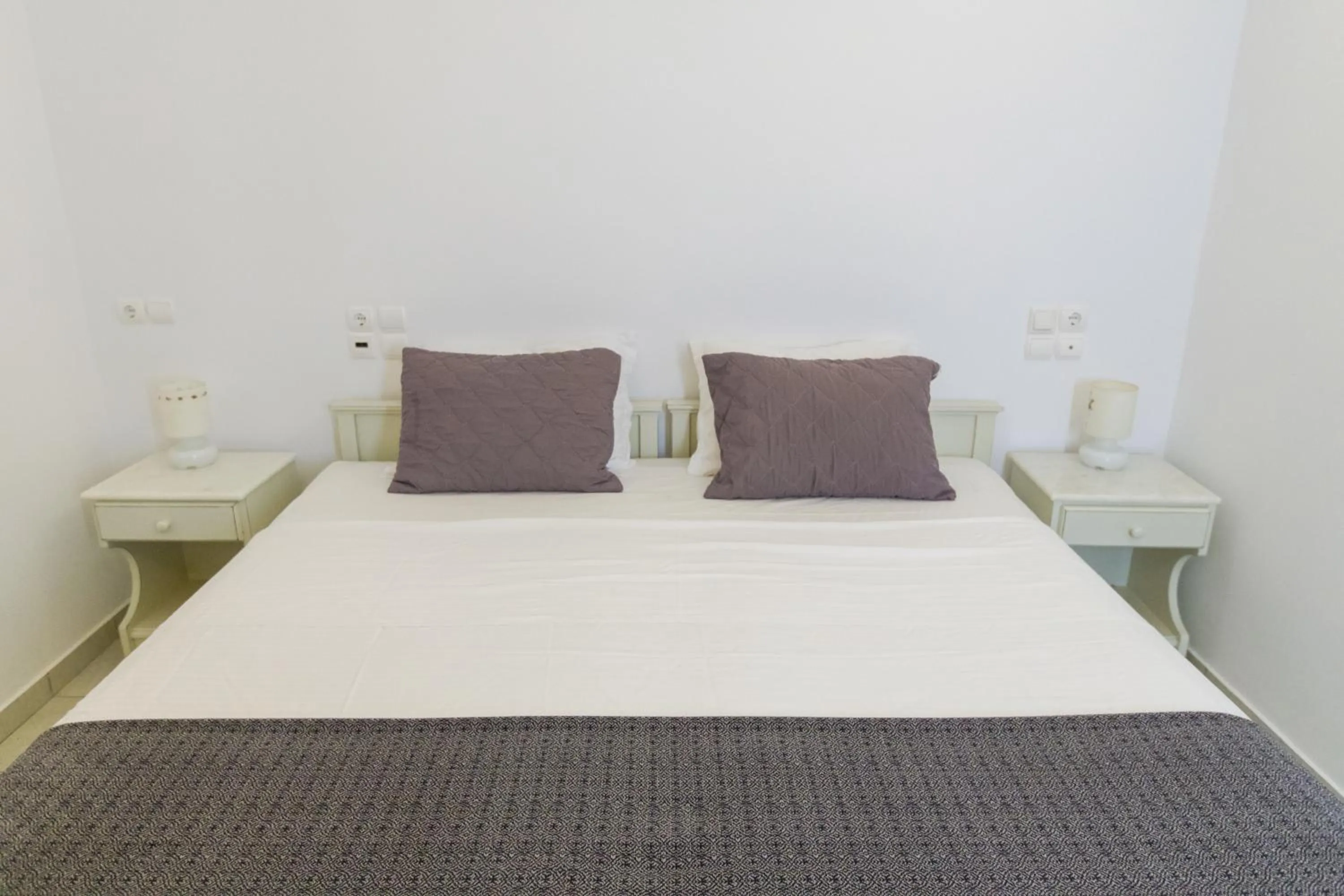 Bed in Alexandros Apartments